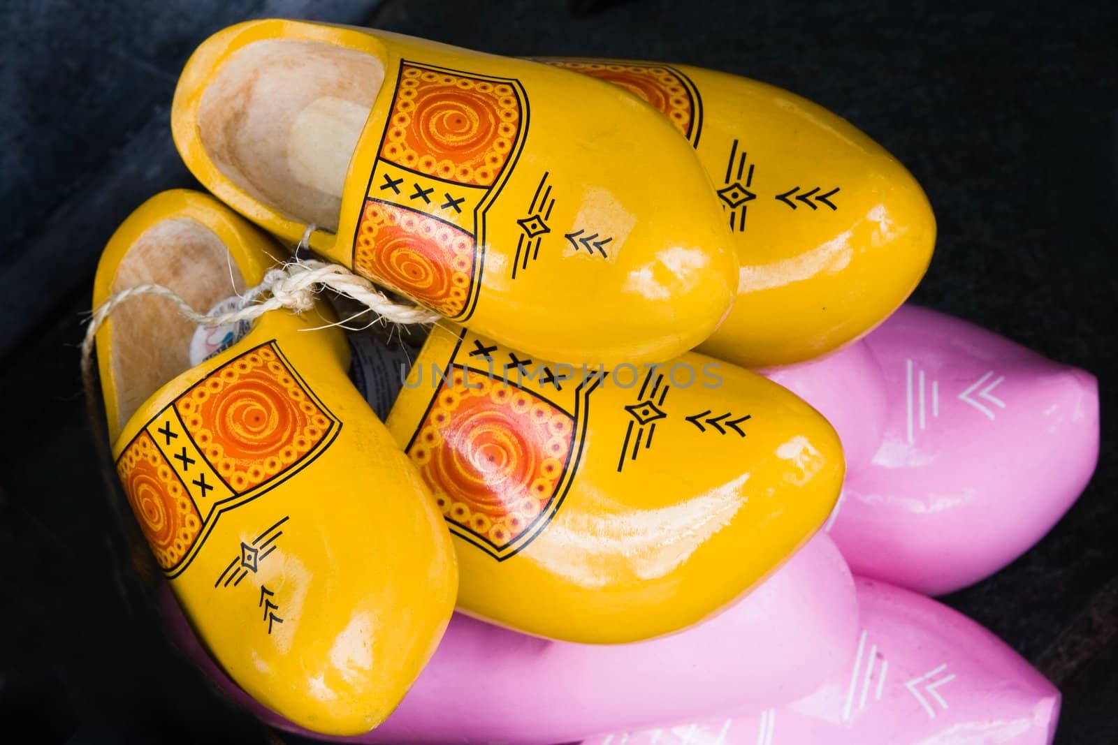 Dutch wooden shoes in different colors and sizes for sale as a souvenir