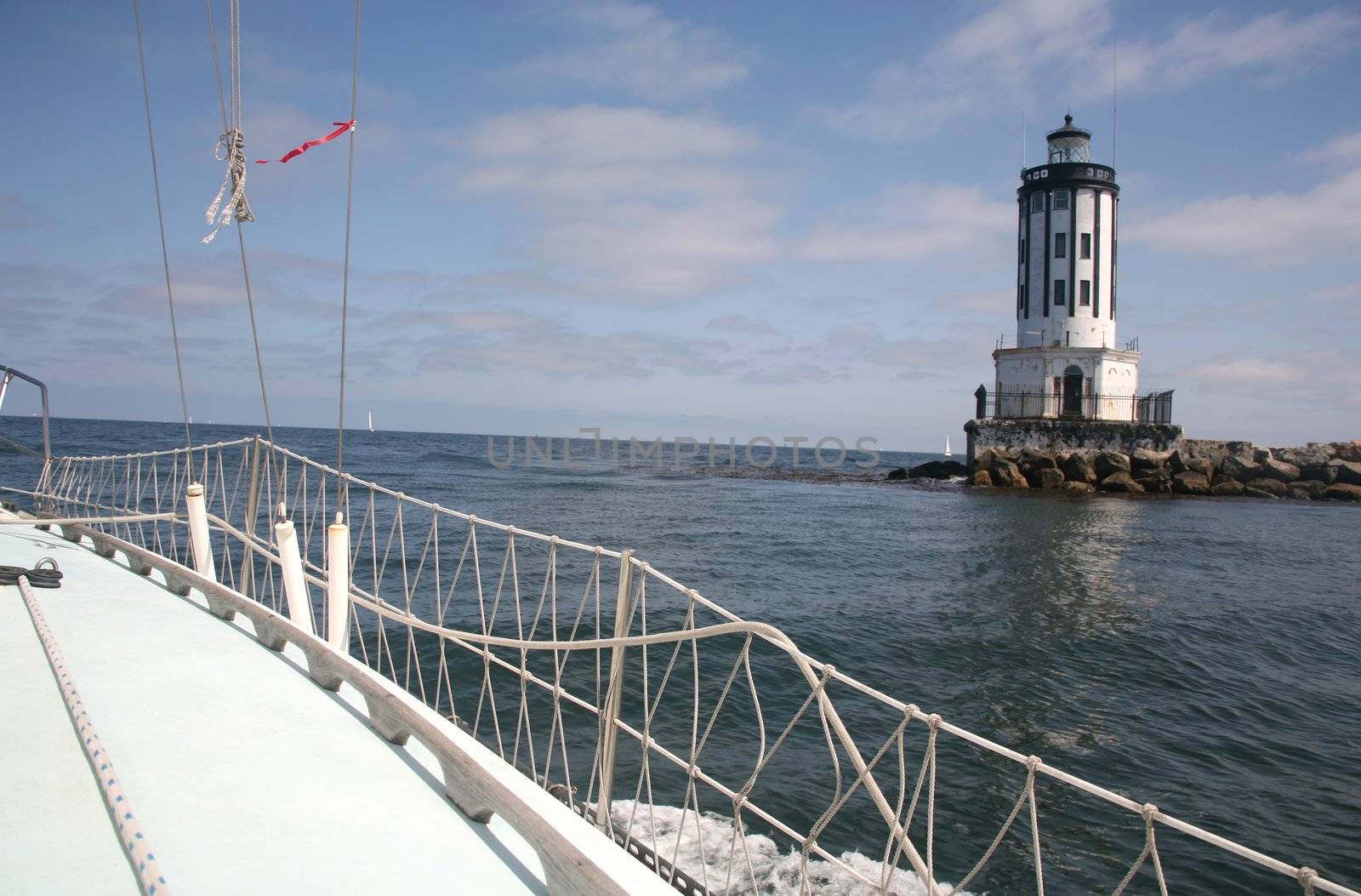 Lighthouse with kelp bed seen from the cockpit of a boat or yacht