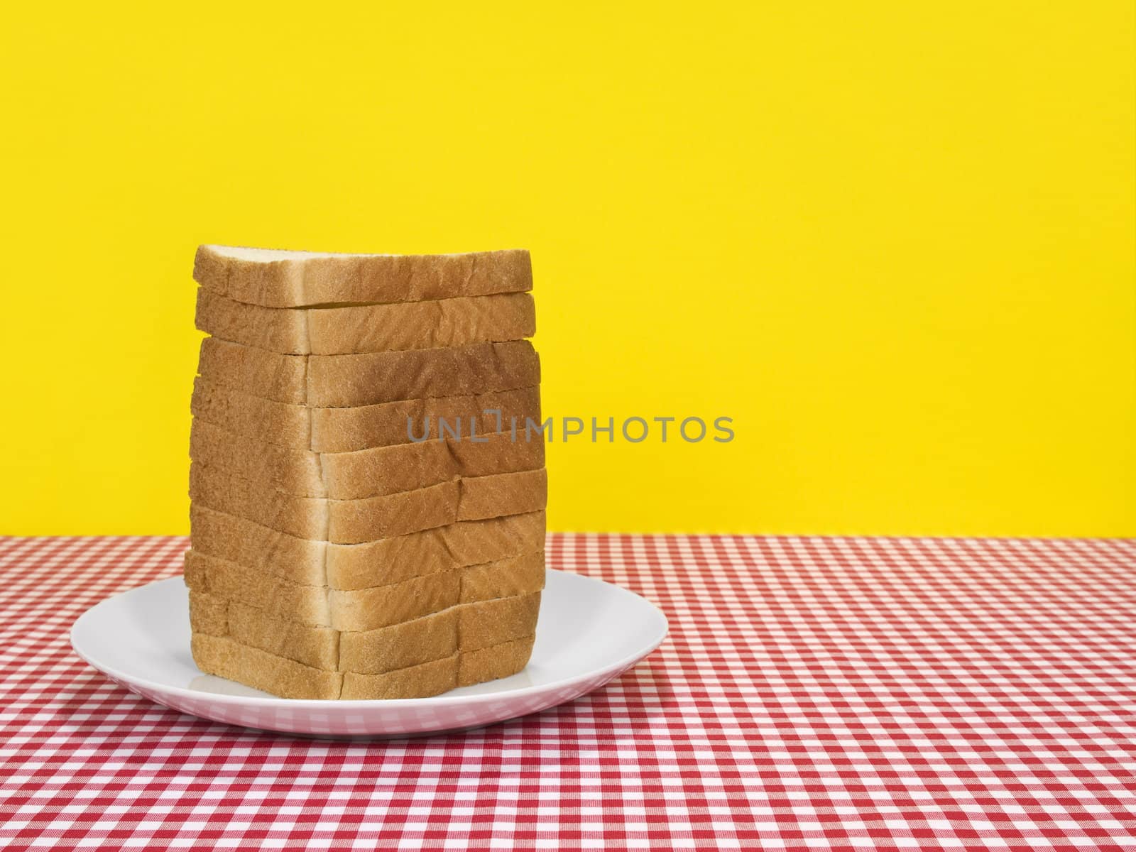 Sliced loaf of bread served on a table. Copy space on the right.