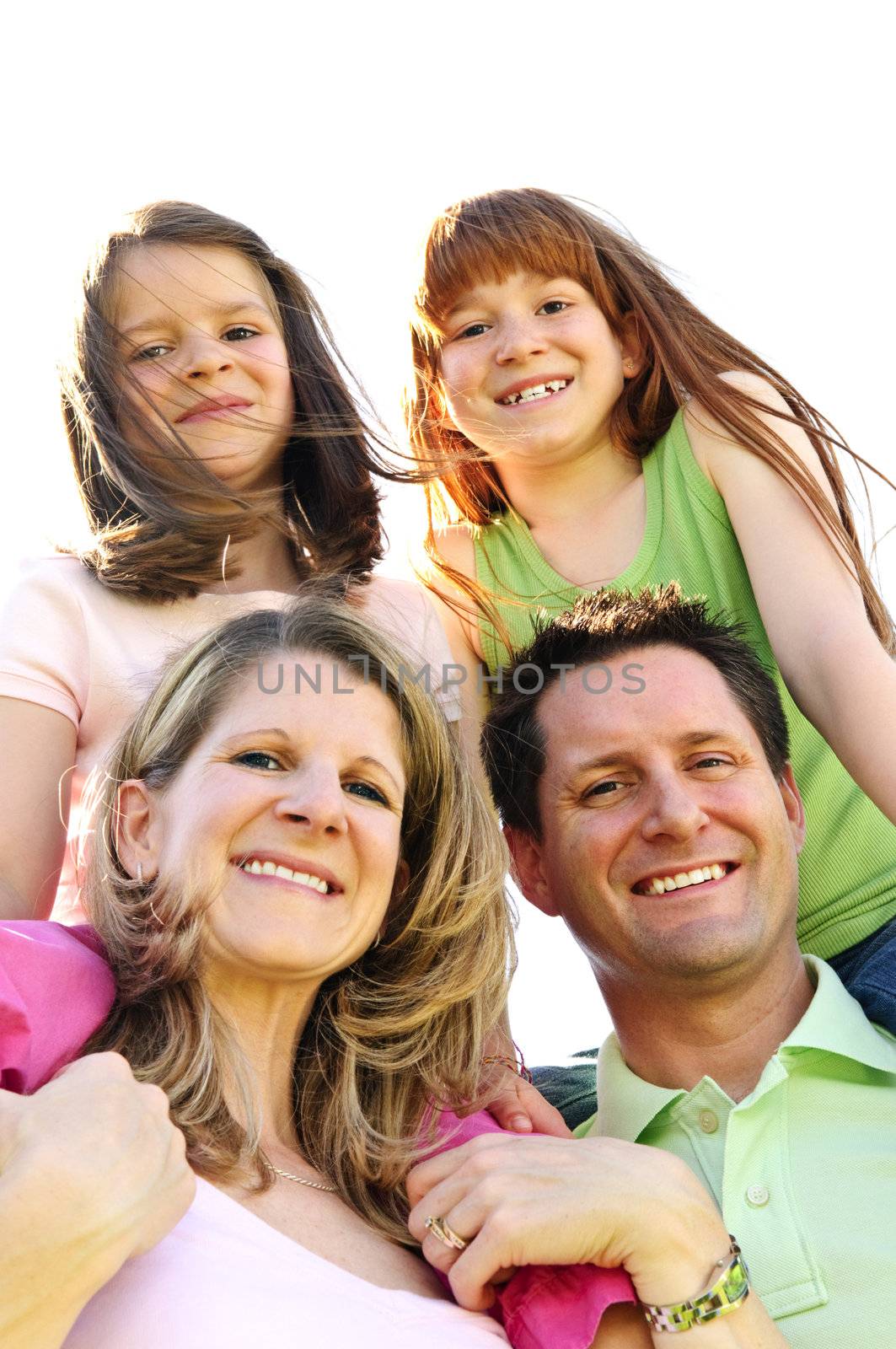 Portrait of happy family giving children shoulder rides