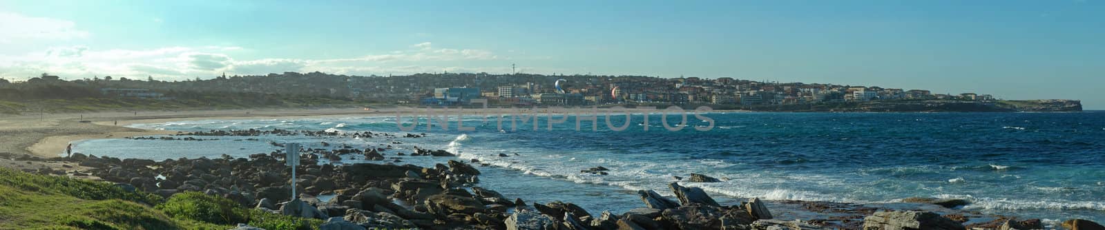 famous maroubra beach in sydney panorama photo, rocks in foreground