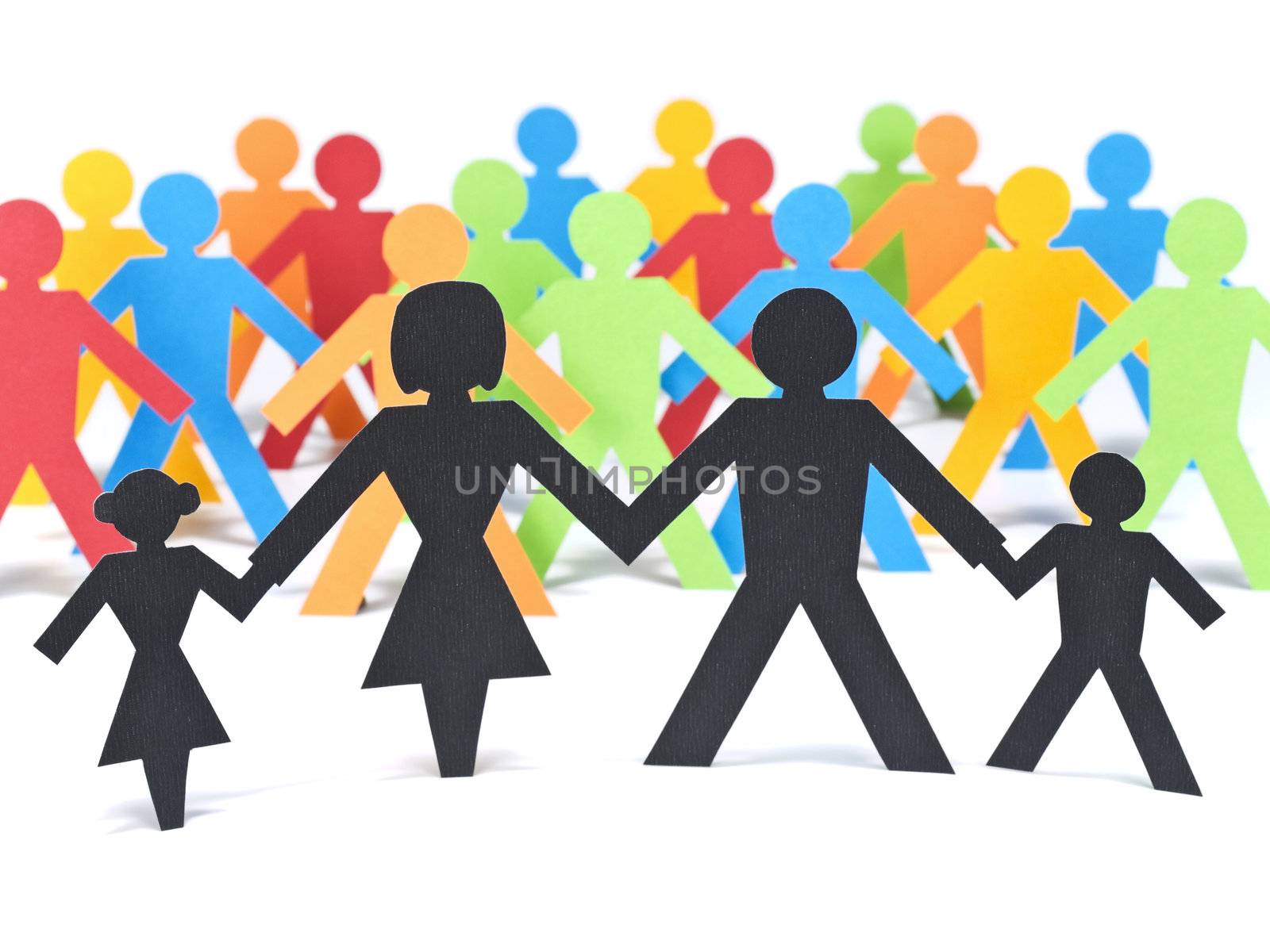 A paper family holding hands in front of a group of multicolor paper men.