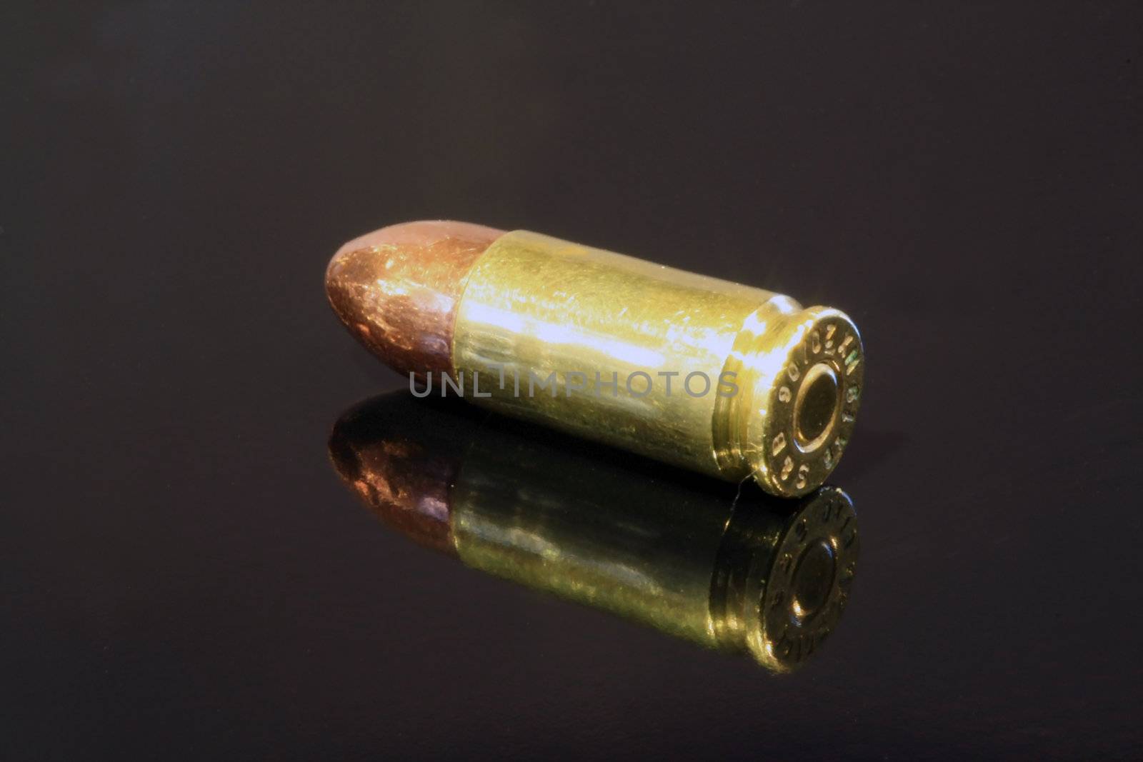 9mm bullet on black surface
