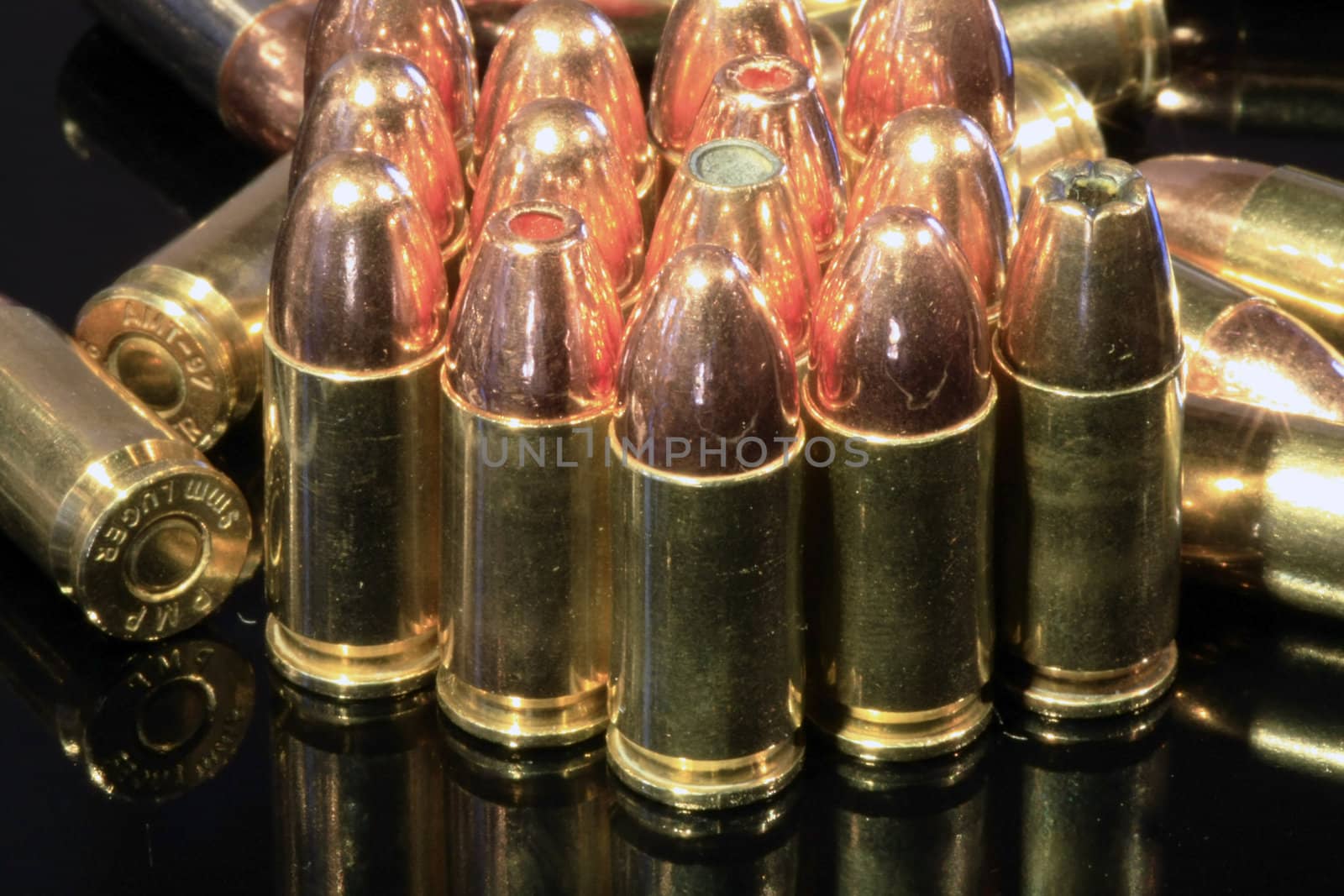 9mm bullets on black surface by ChrisAlleaume