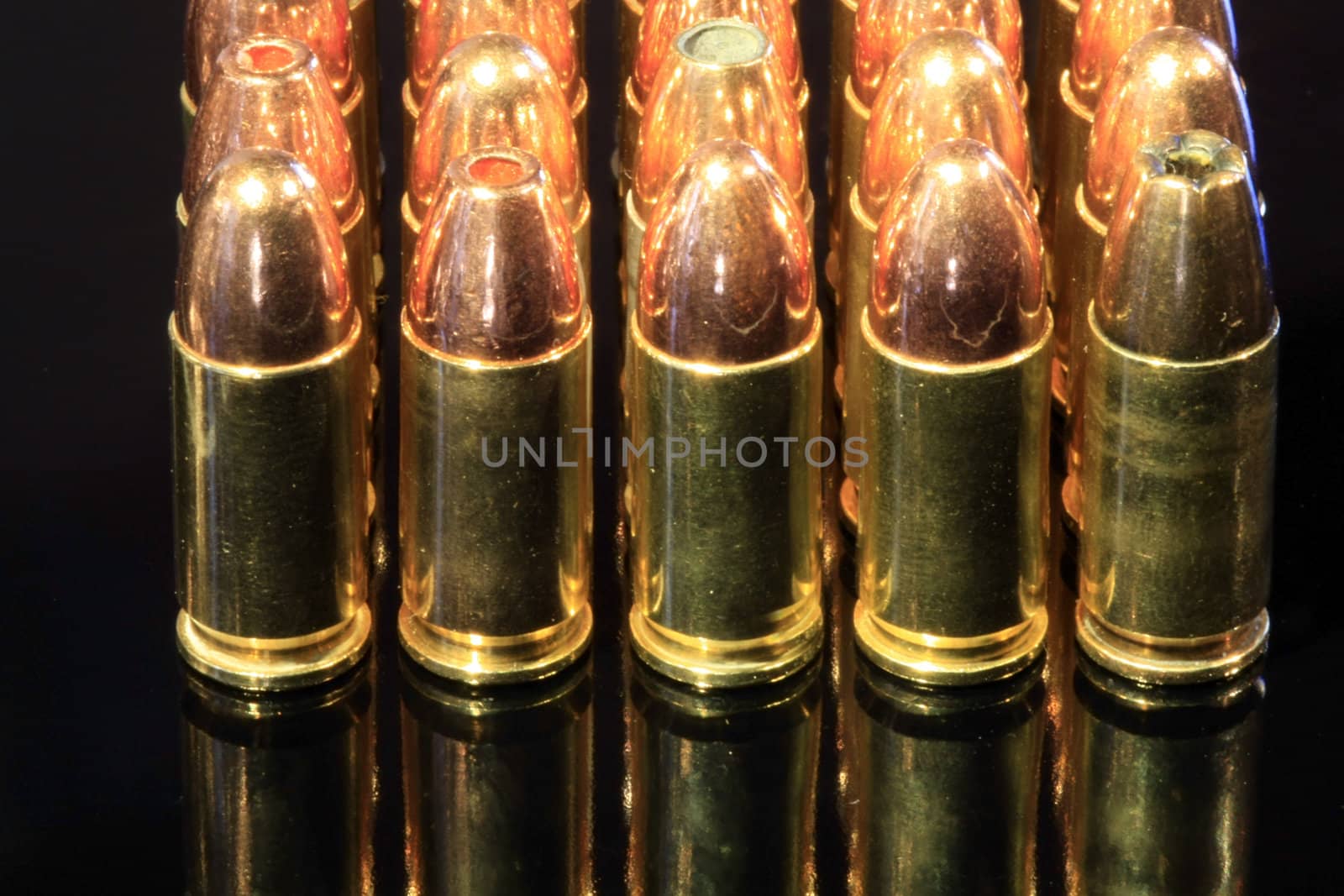 Various 9mm bullets on black surface