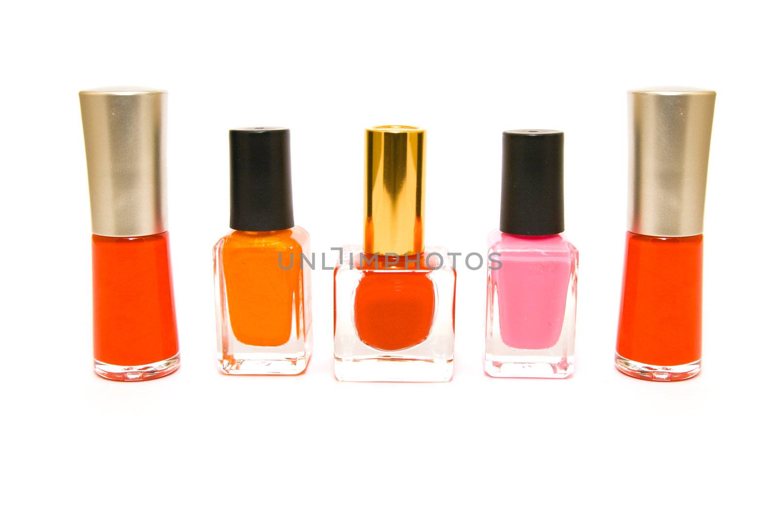 Five bottles of red, pink and orange nail polish on a white background        