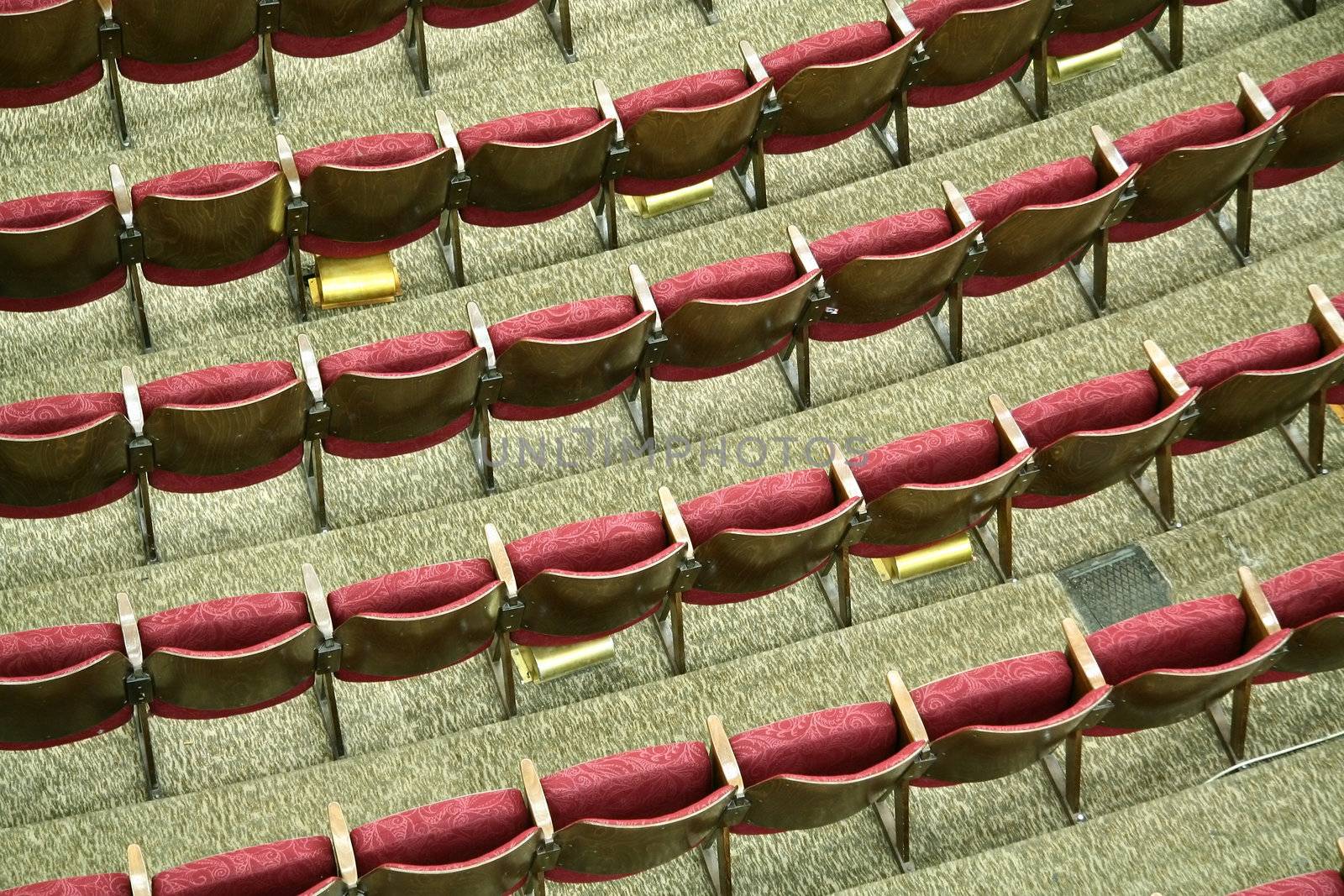 purple empty cinema seats with white numbers, photo taken from roof