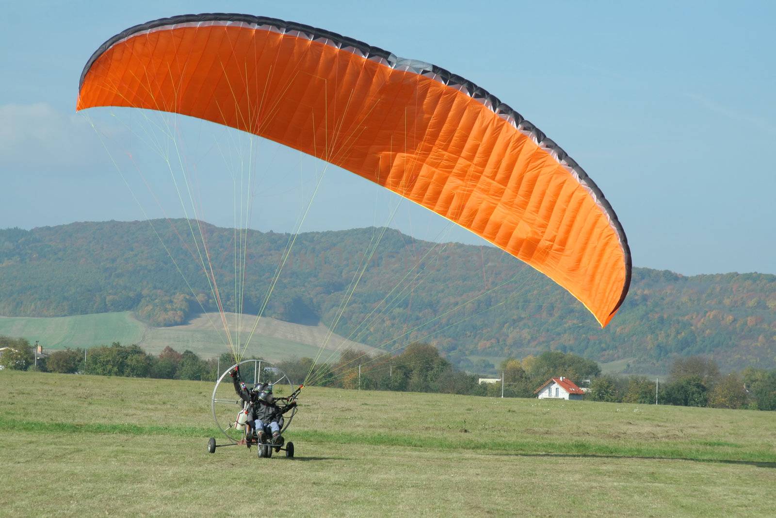 paragliding trike with two people trying to take off