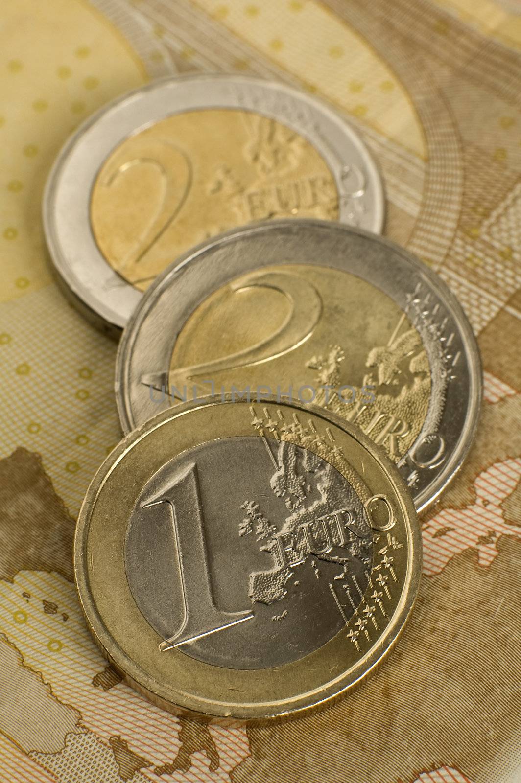 one and two euro coins on fifty euro bank note