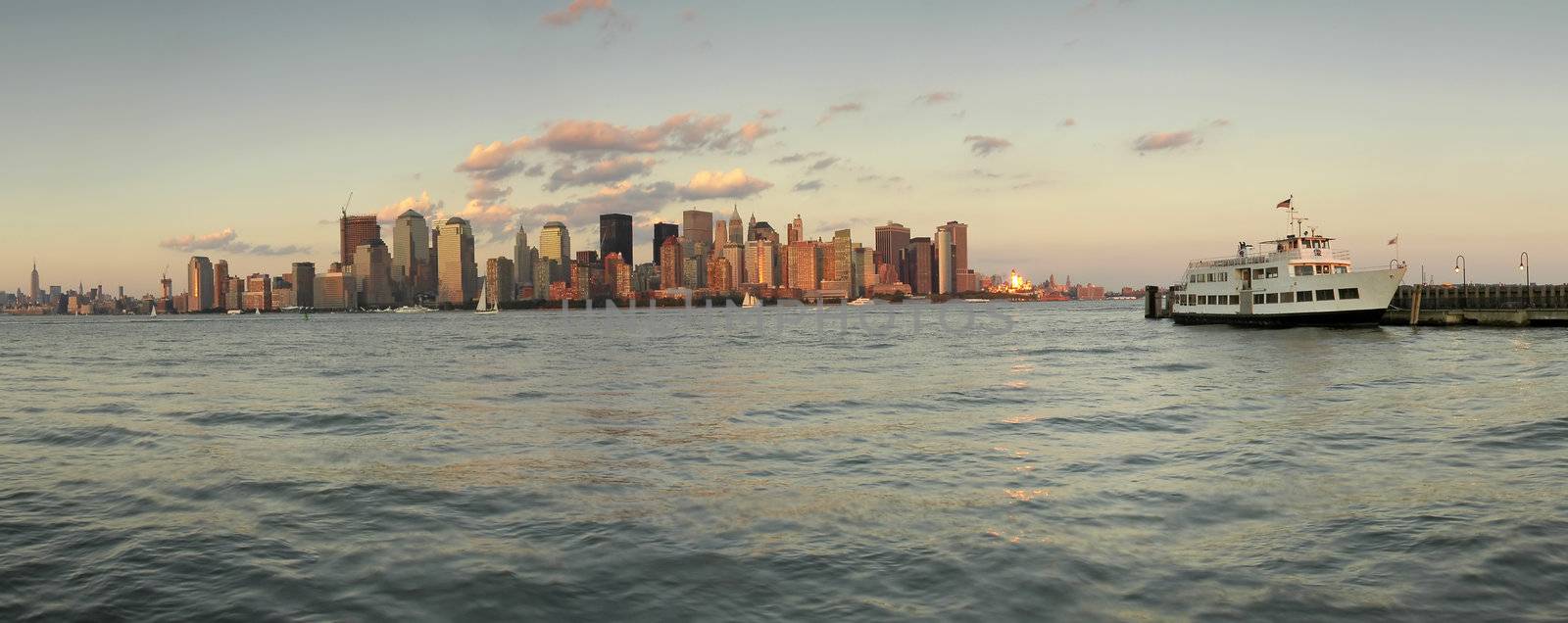 new york's manhattan panorama, photo taken from ellis island, white boat anchoring