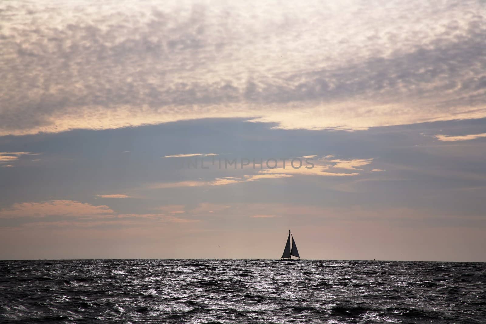 Lone sailboat on horizon by scrappinstacy