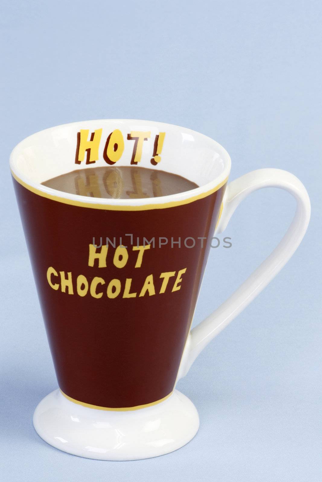A mug of hot chocolate over light blue background