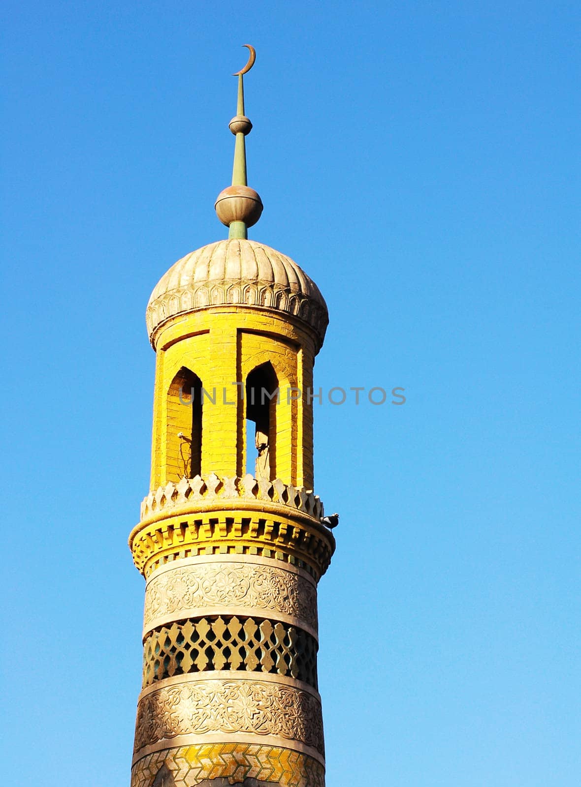 Landmark of the yellow roof of a famous mosque with blue sky as background