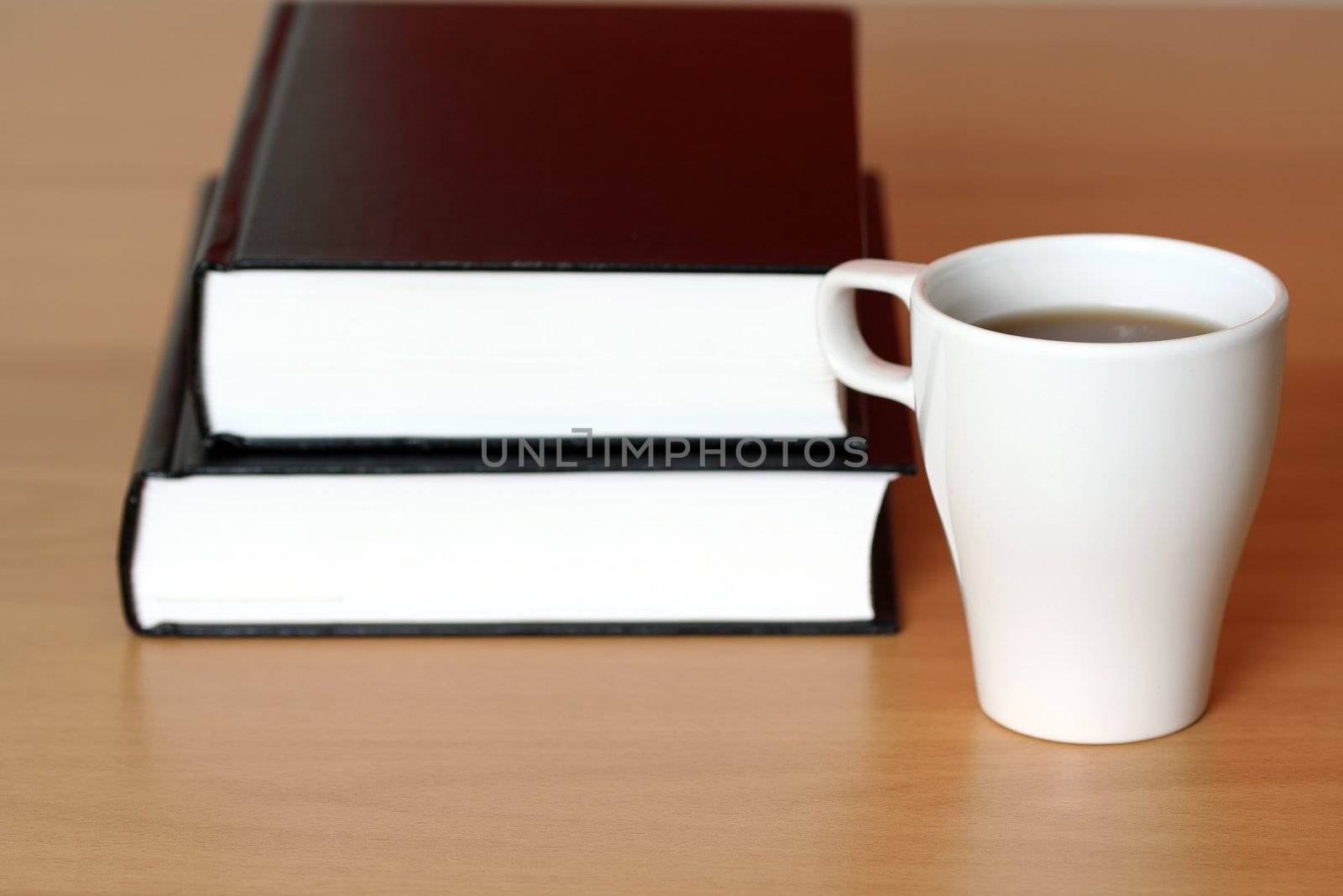 A cup of coffee and books