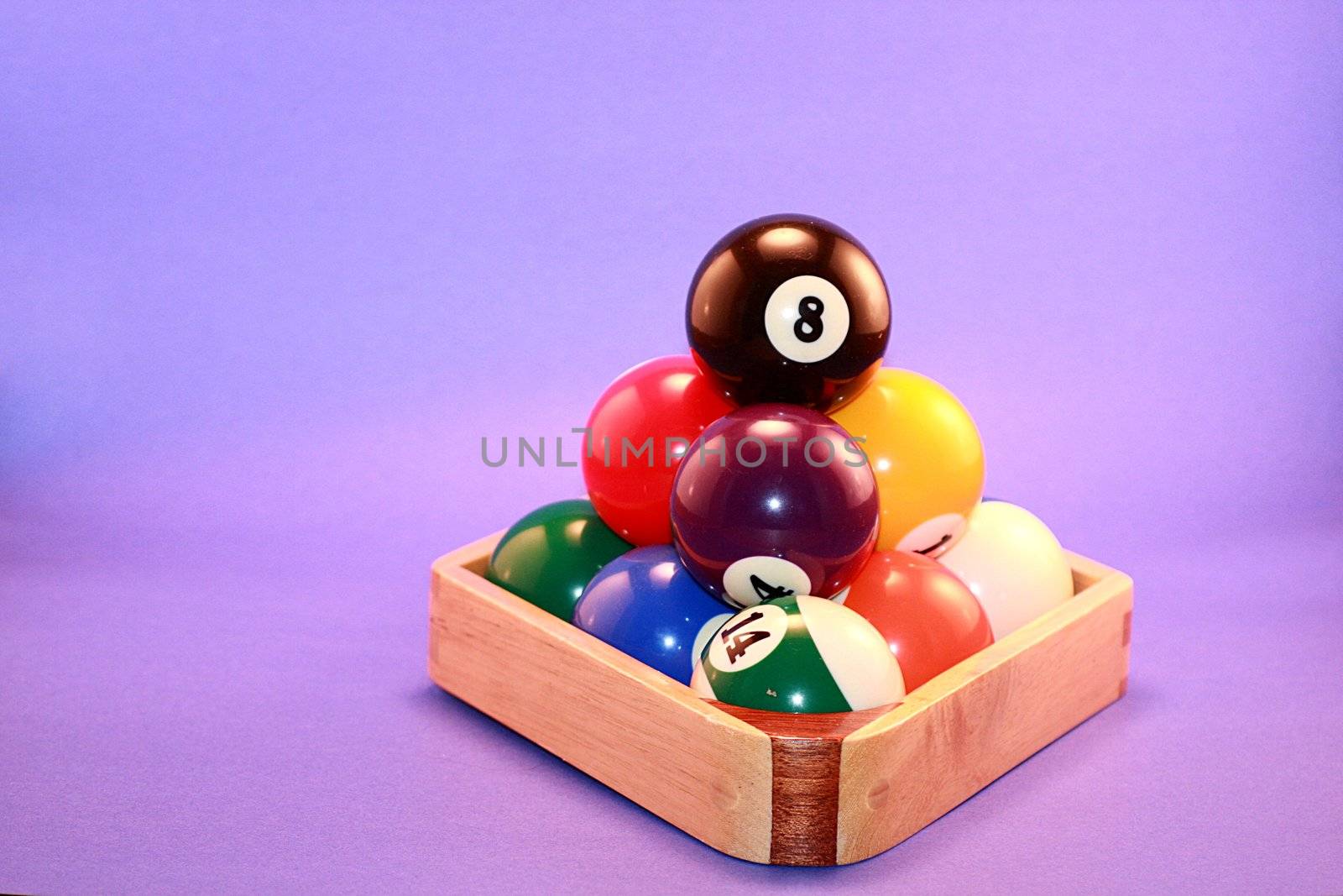 Stacked pool balls for billiards game on blue background.