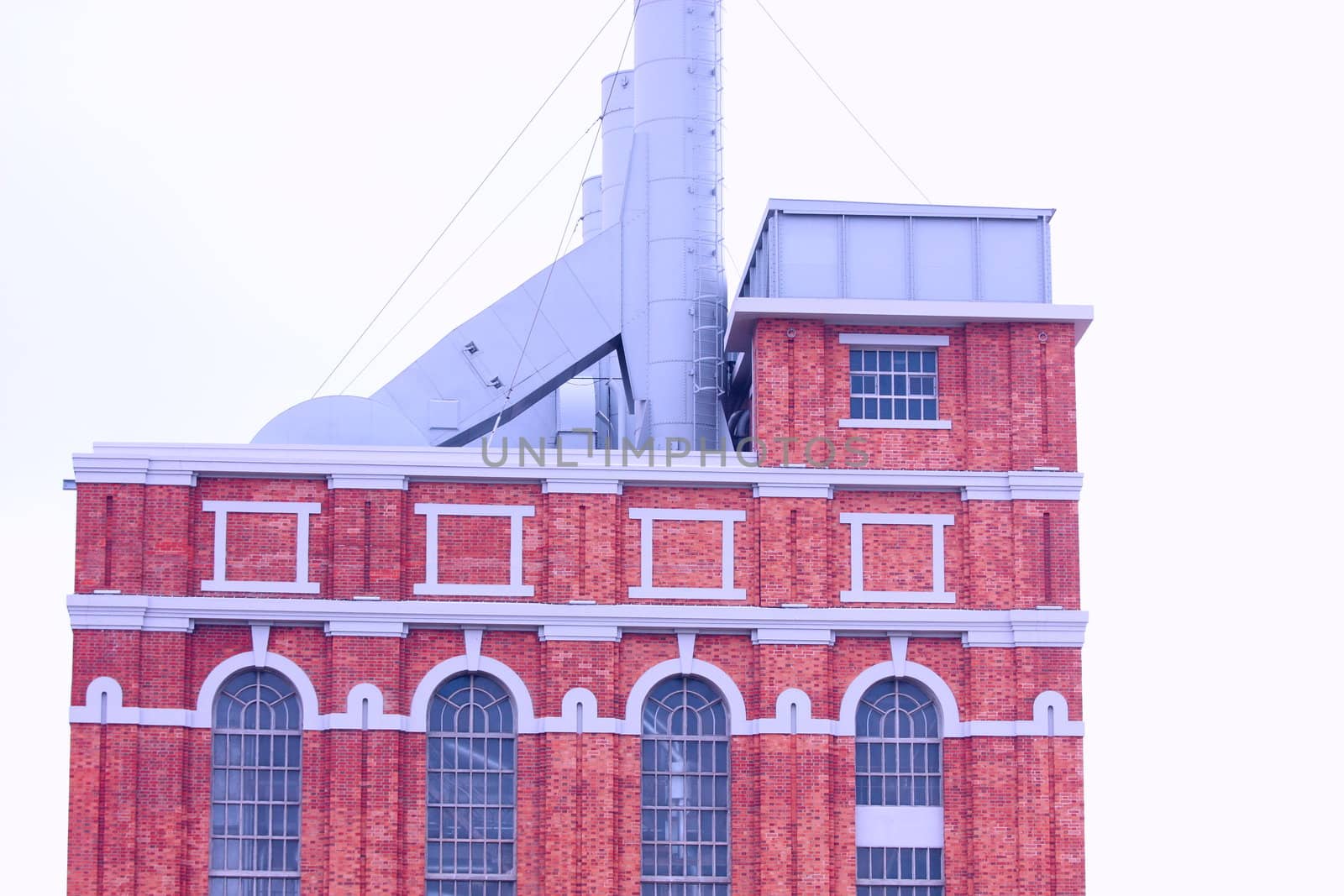 Building of antique factory with chimney