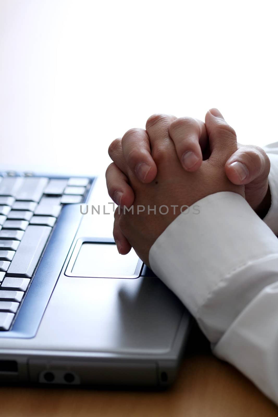 Businessman thinking while working on a laptop