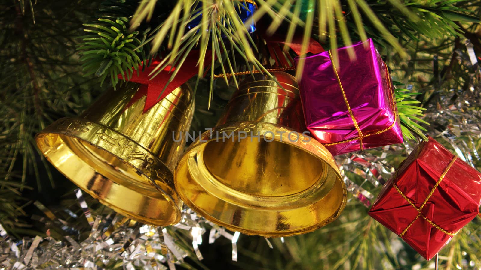 Decorations of golden Christmas bells in the fir tree
