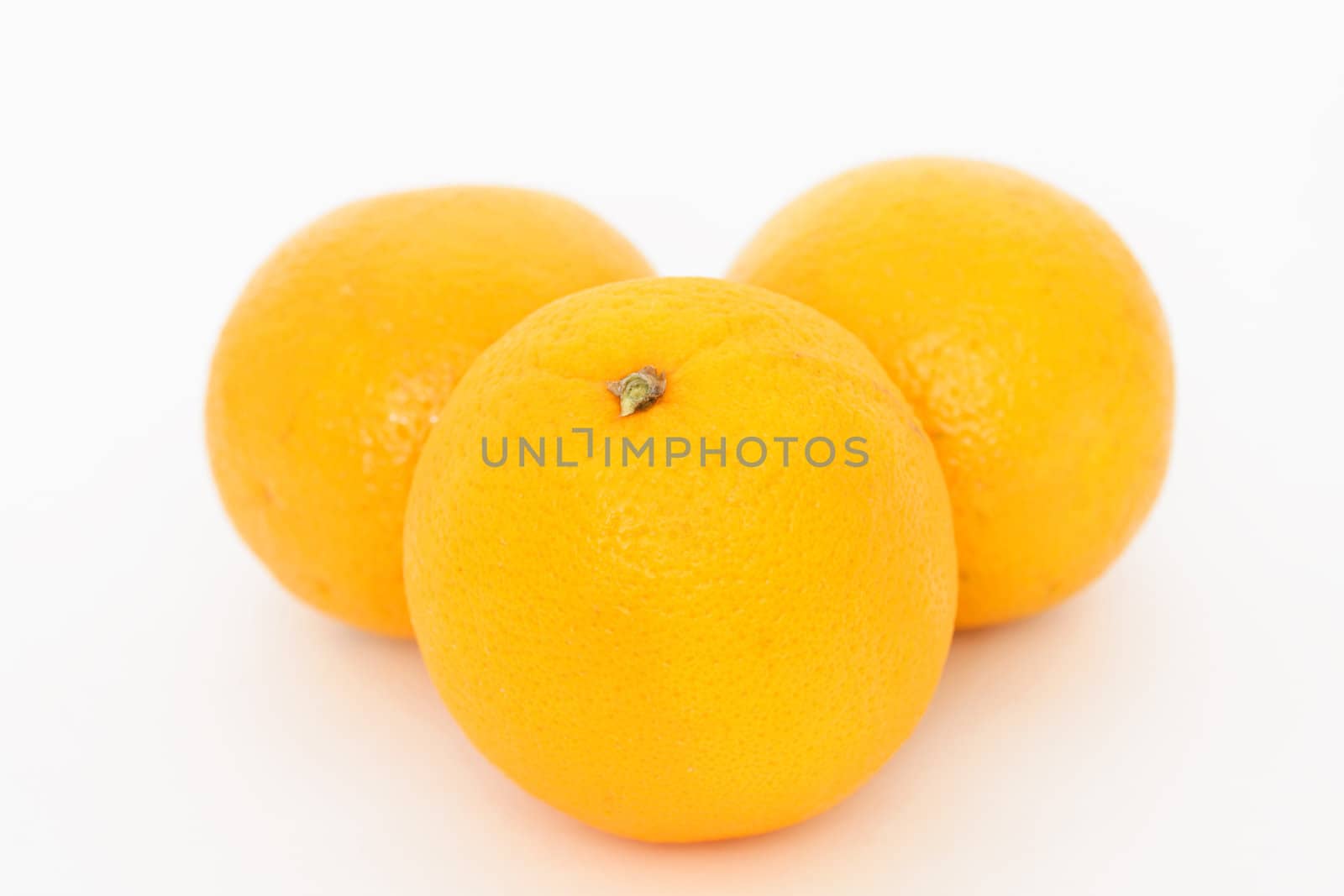 Three oranges over white background