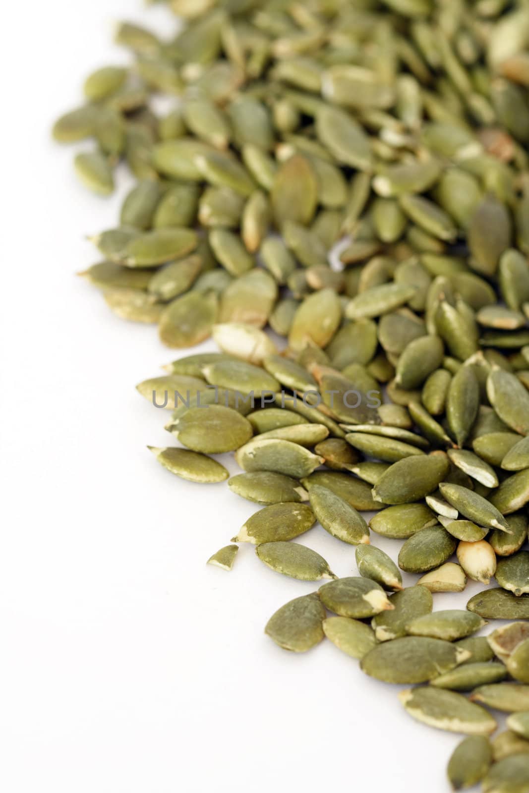 Pile of pumpkin seeds over white background