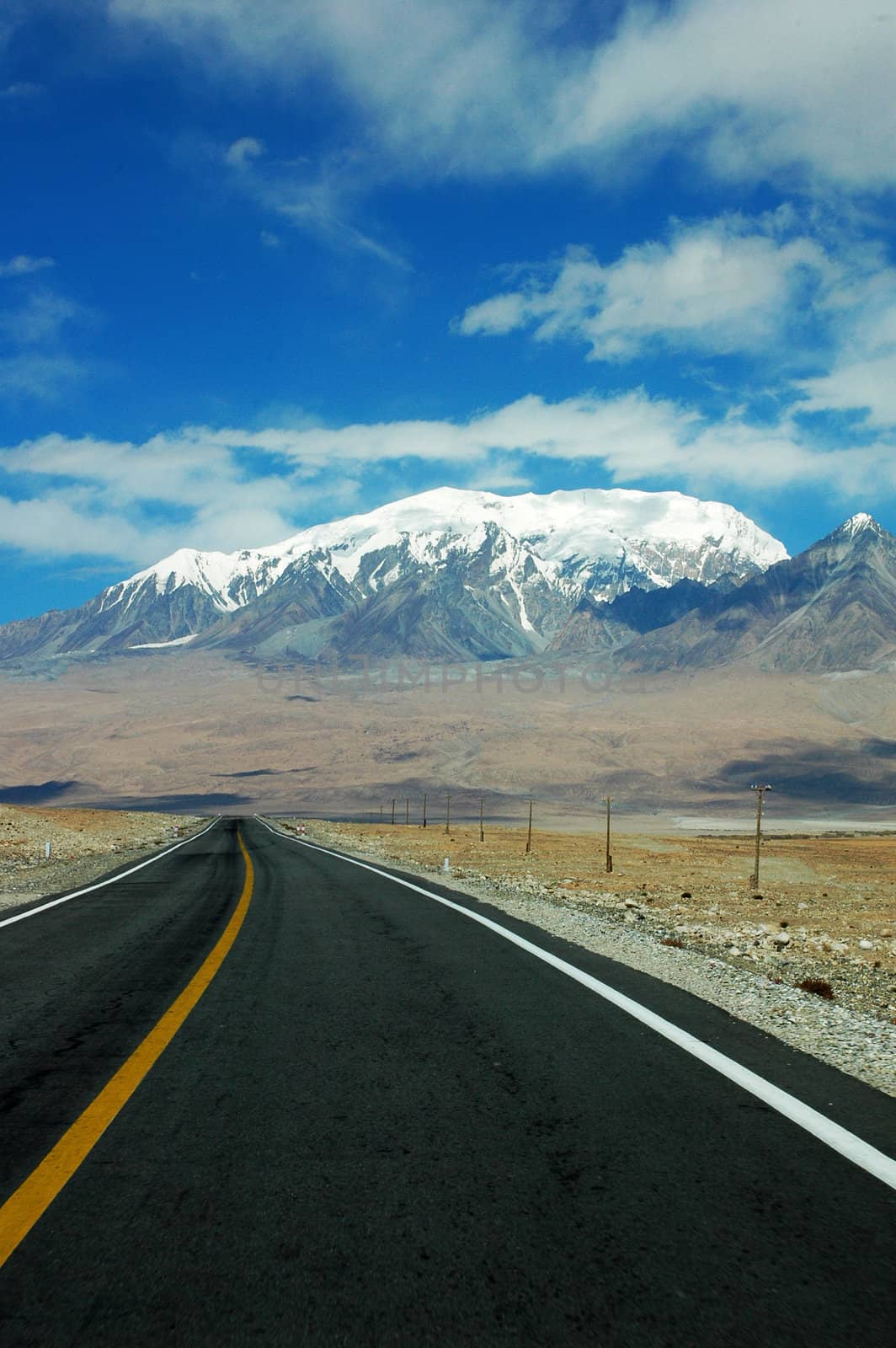 Landscape of a highway extending to the snow mountains