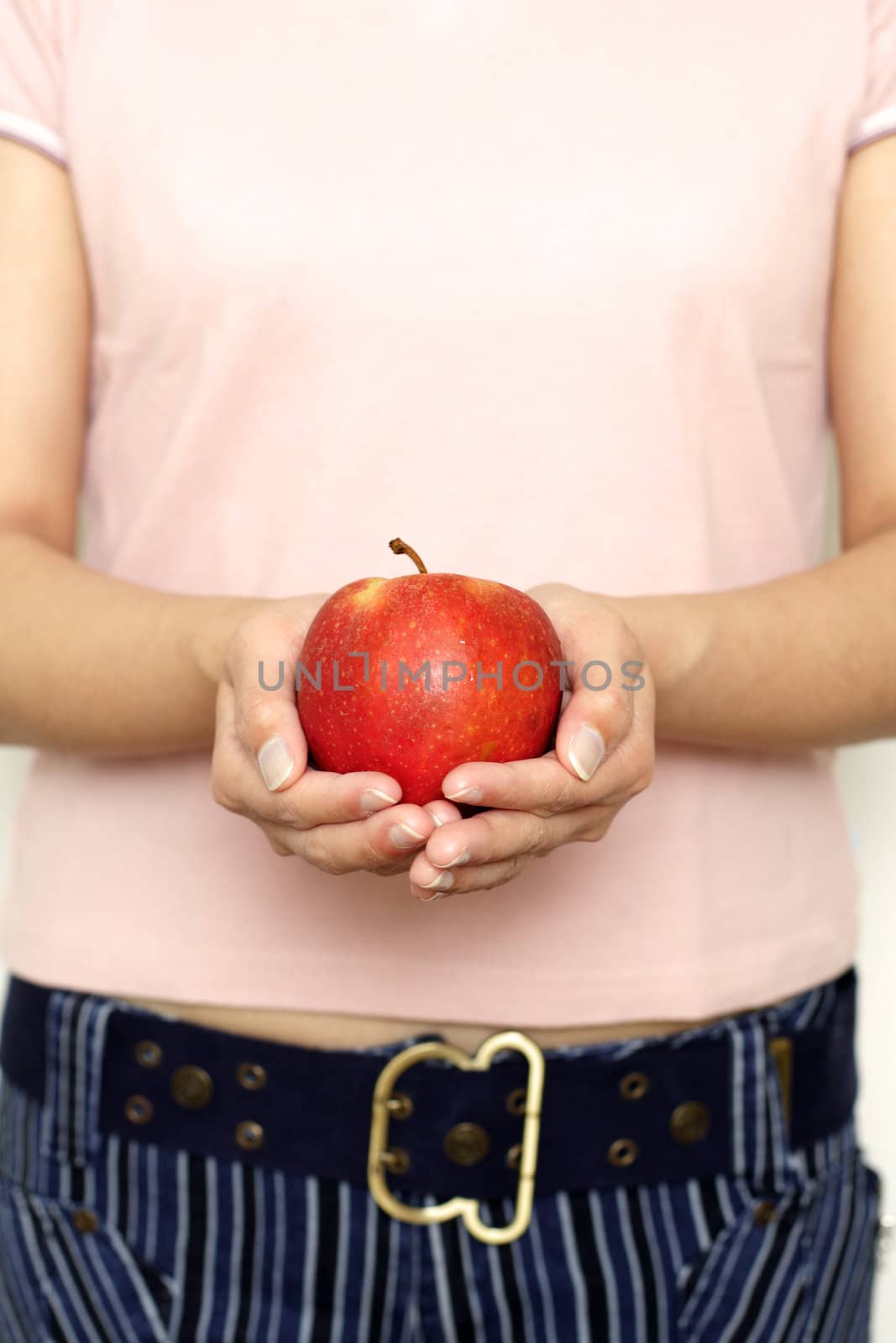 A woman holding an apple, can be used for health/nutrition theme