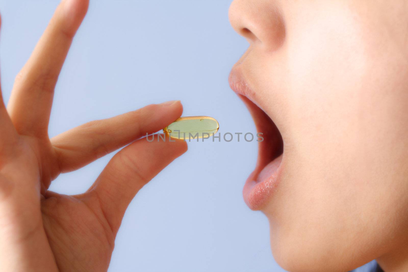 A woman taking a pill/vitamin