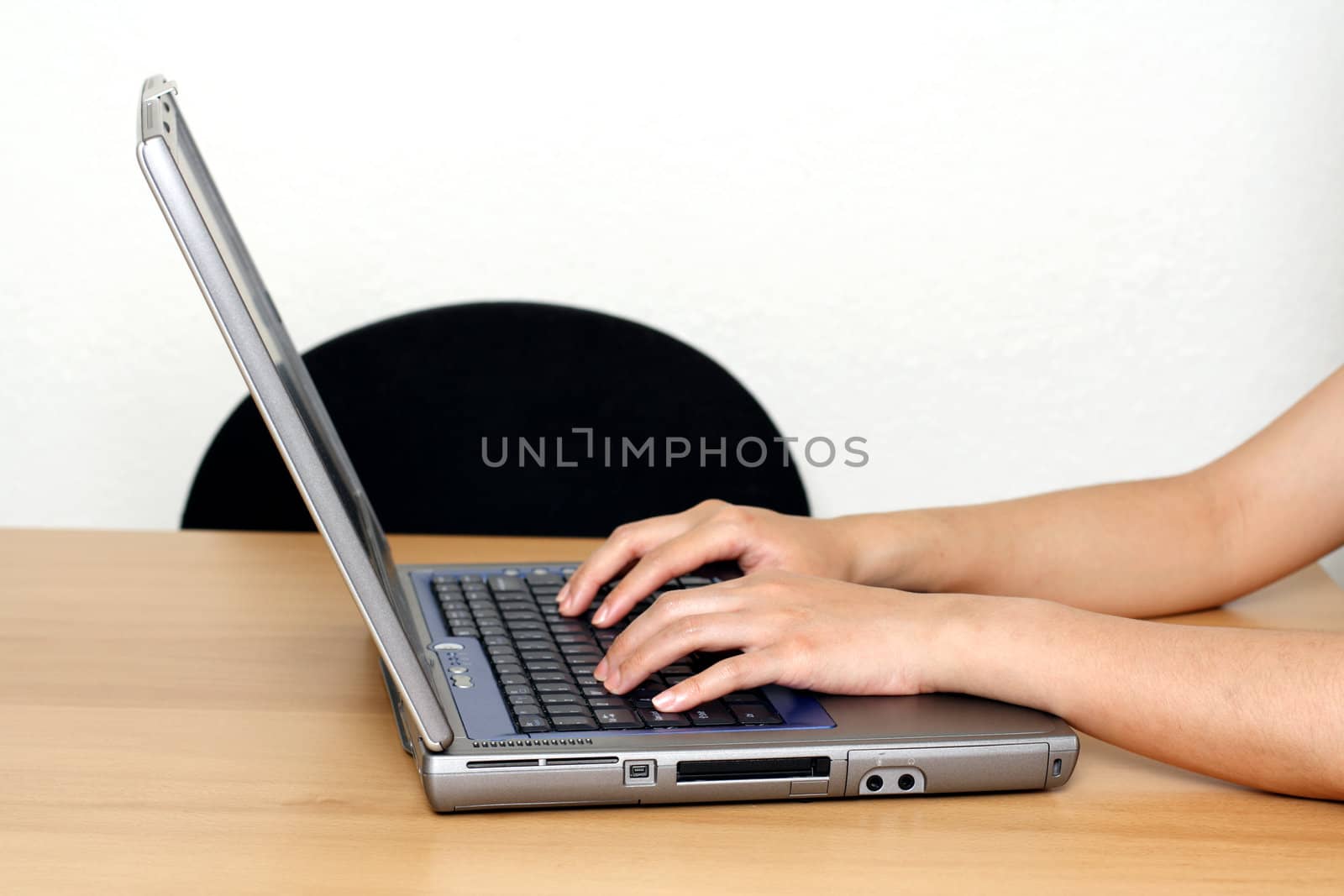 Businesswoman typing on a laptop