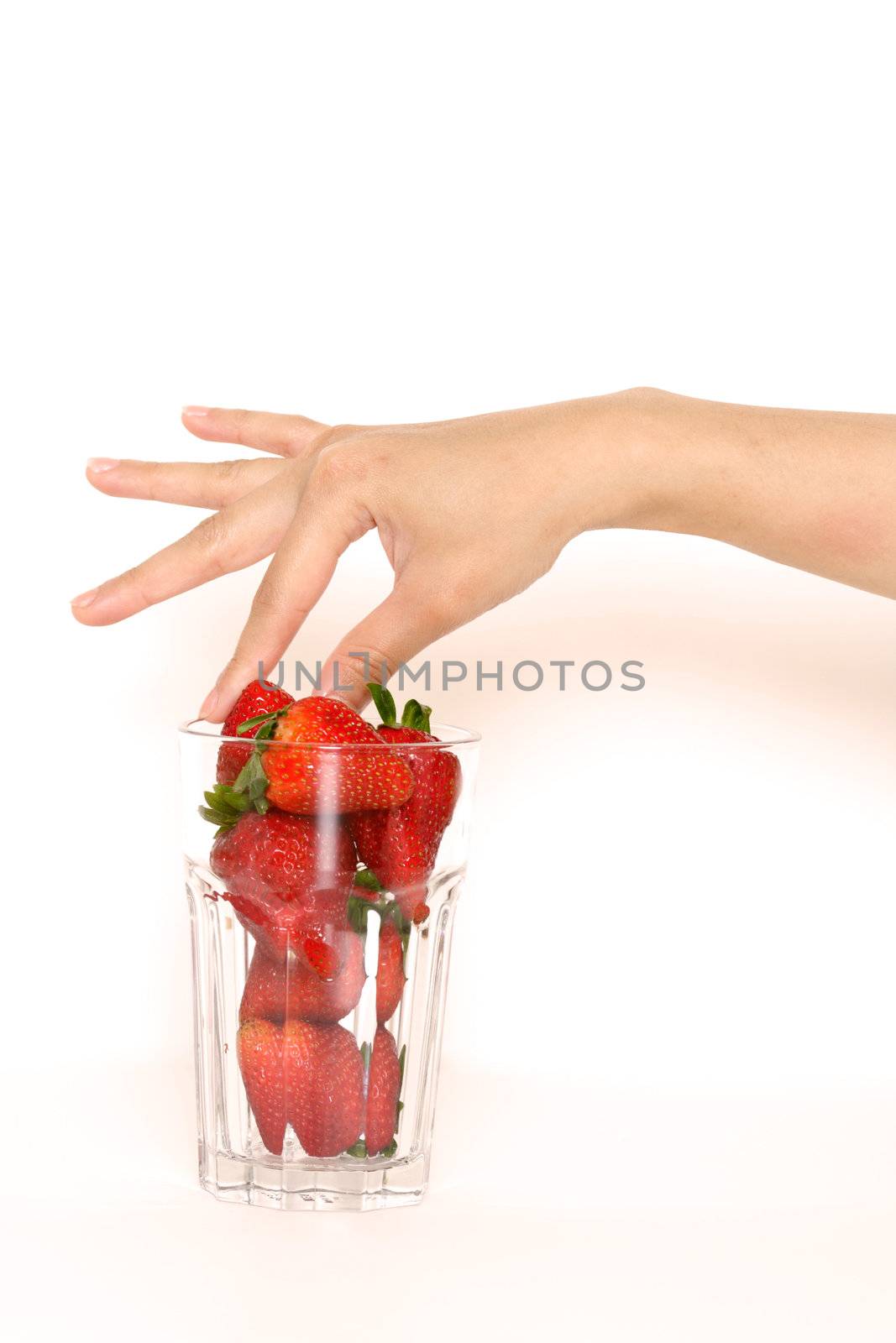 Picking a strawberry to eat