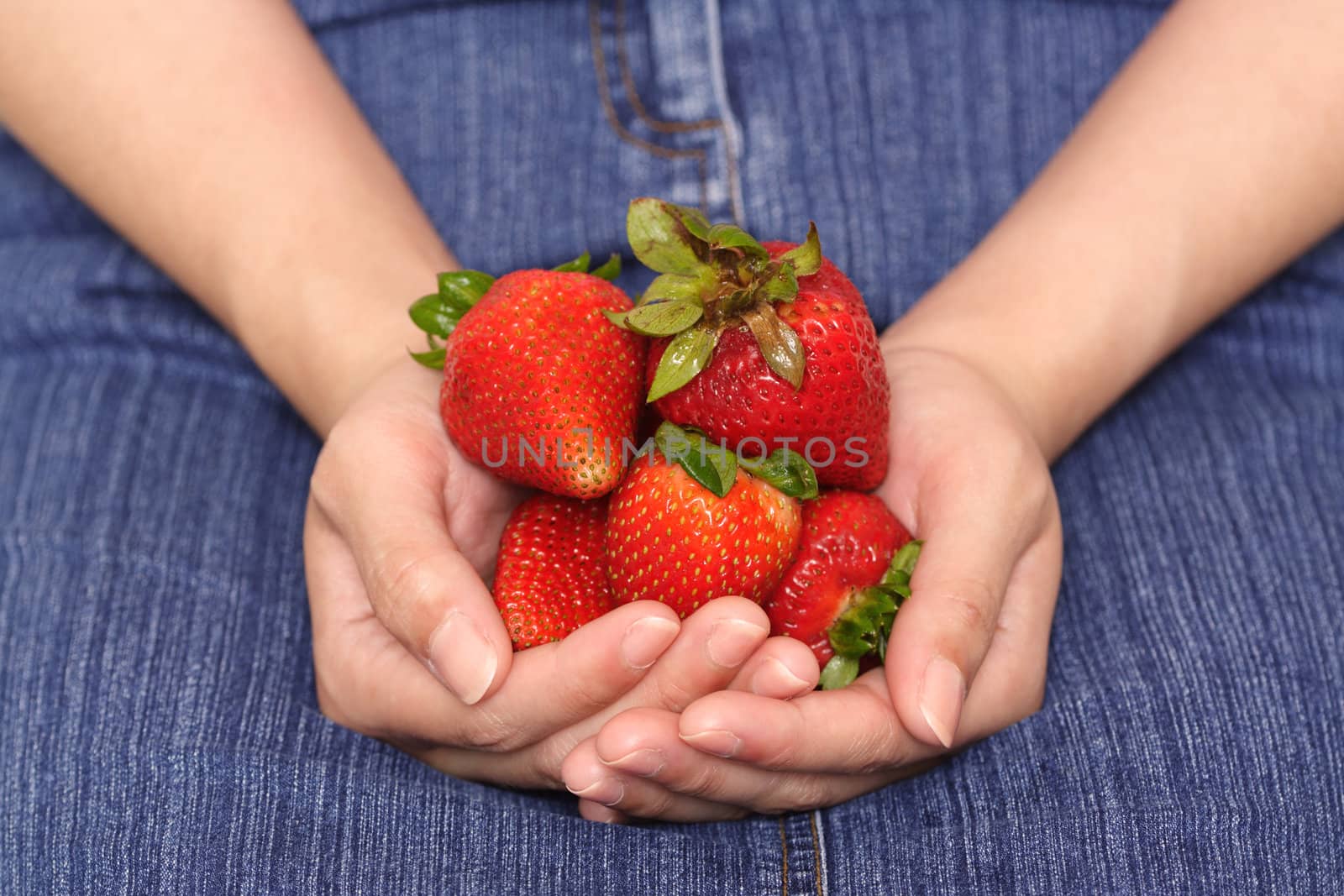 A woman holding strawberries