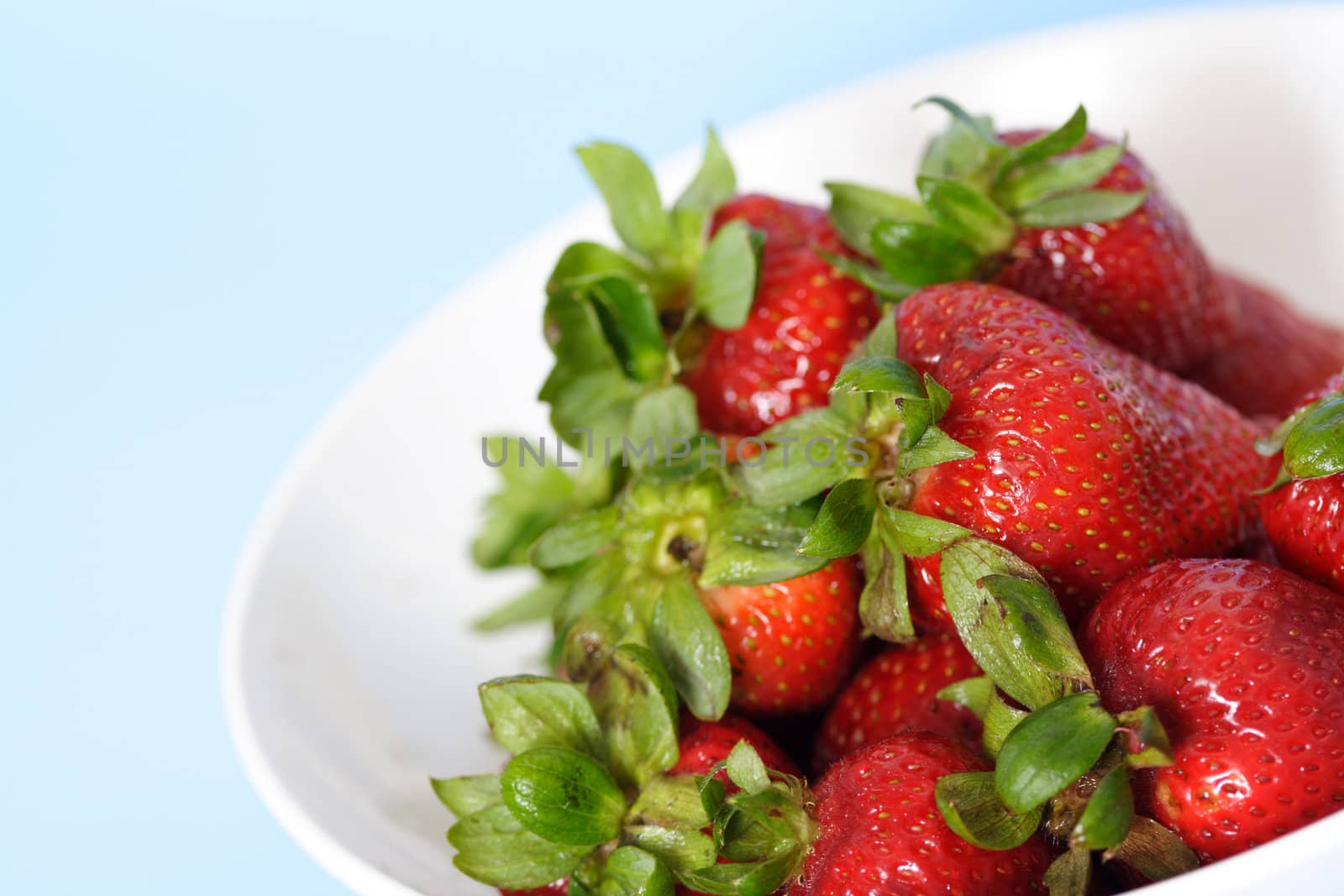 Strawberries in a bowl by aremafoto