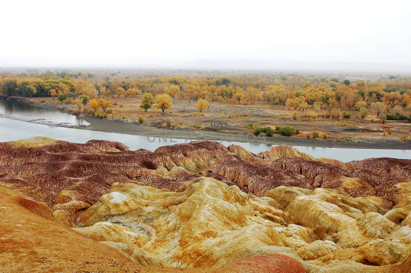 Landscape of colorful hills by the river in autumn