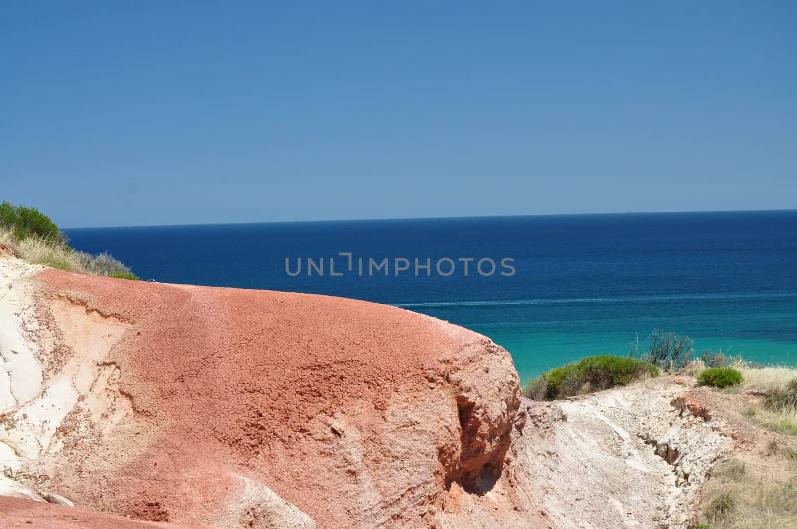 Beautiful azure, blue water beach with red stone. Hallett Cove Conservation Park, South Australia.