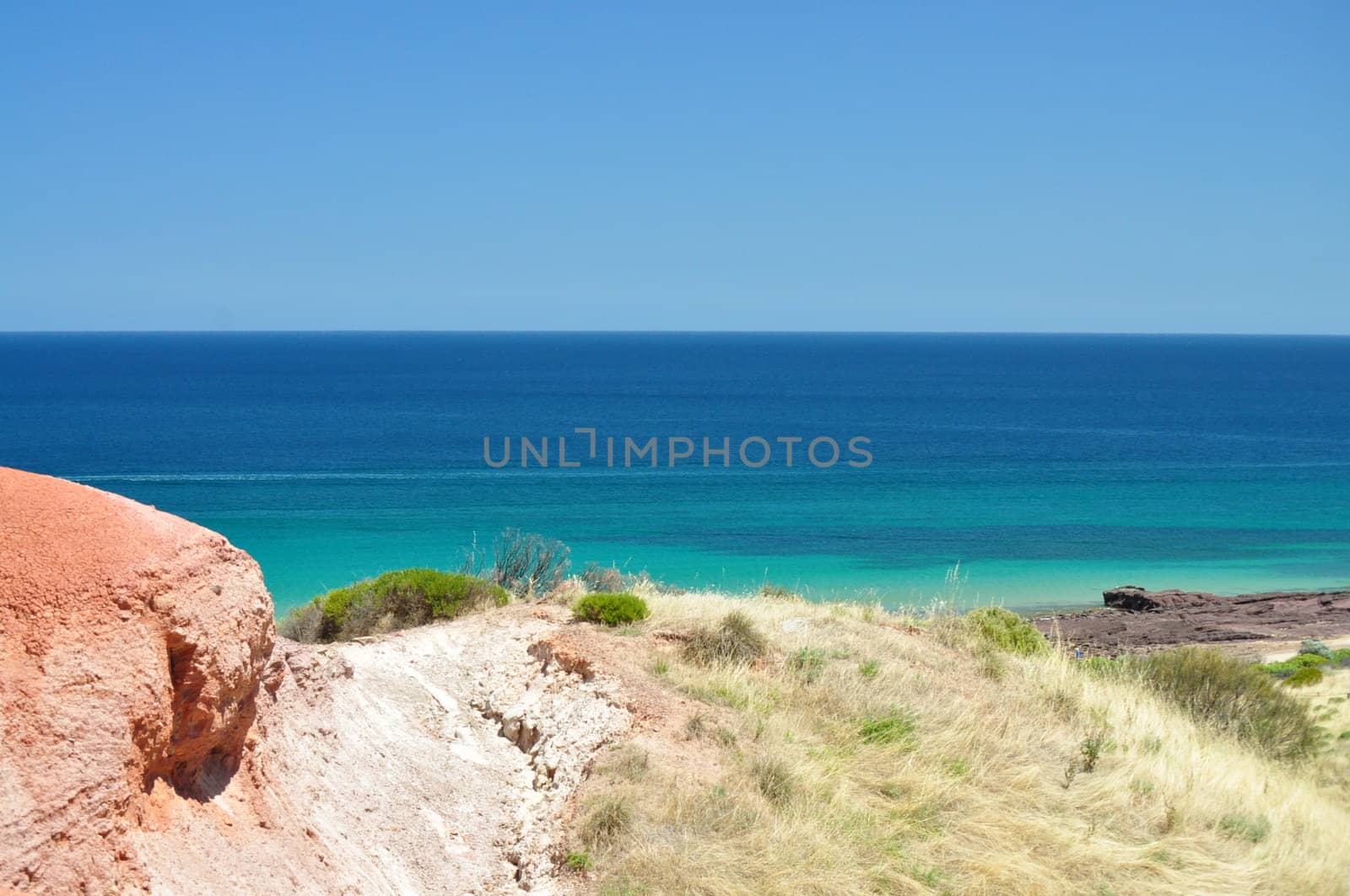 Beautiful azure, blue water beach with red stone. Hallett Cove Conservation Park, South Australia.