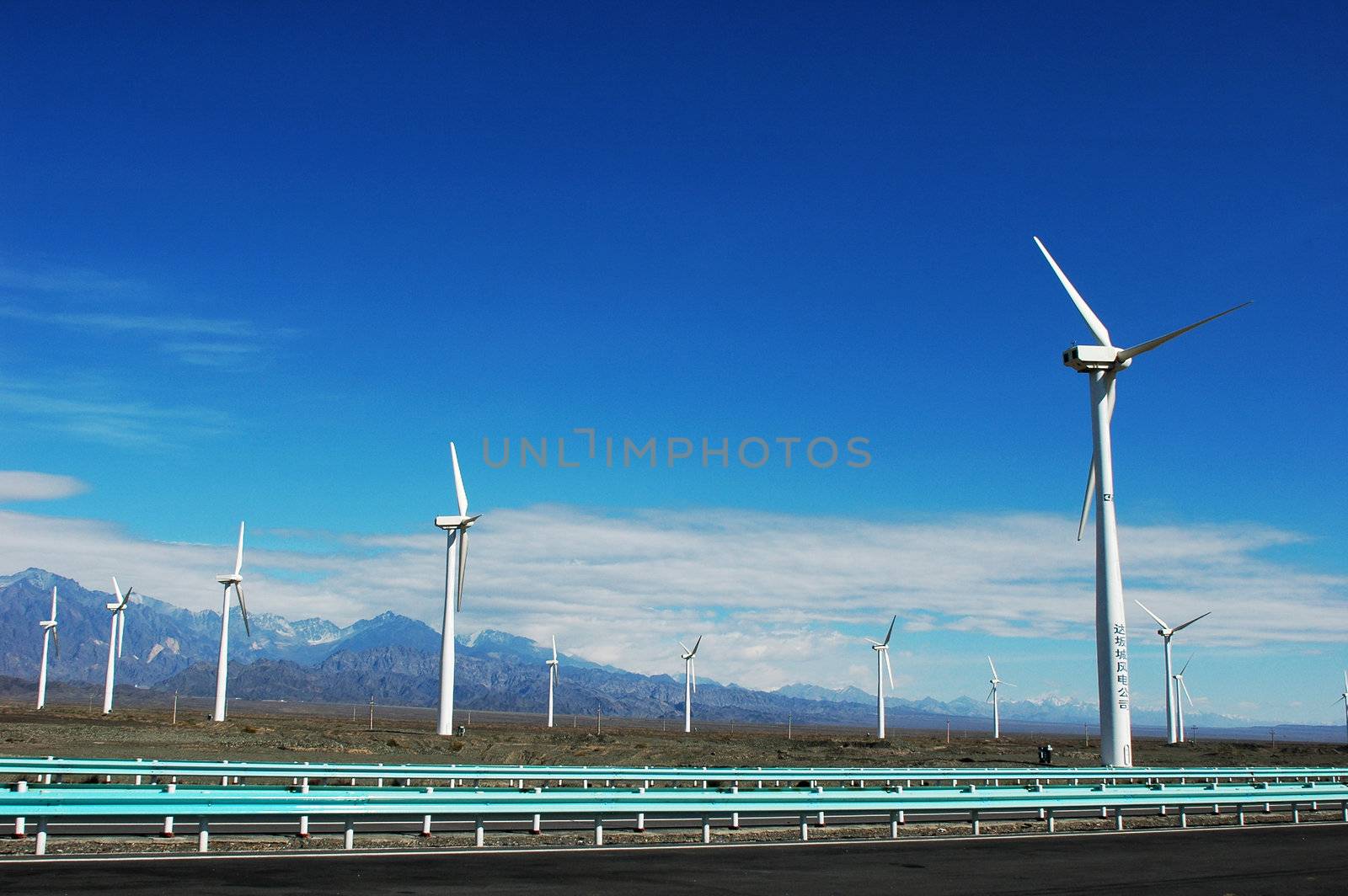 Wind turbine generators in sinkiang,china,with blue skies and white clouds as backgrounds