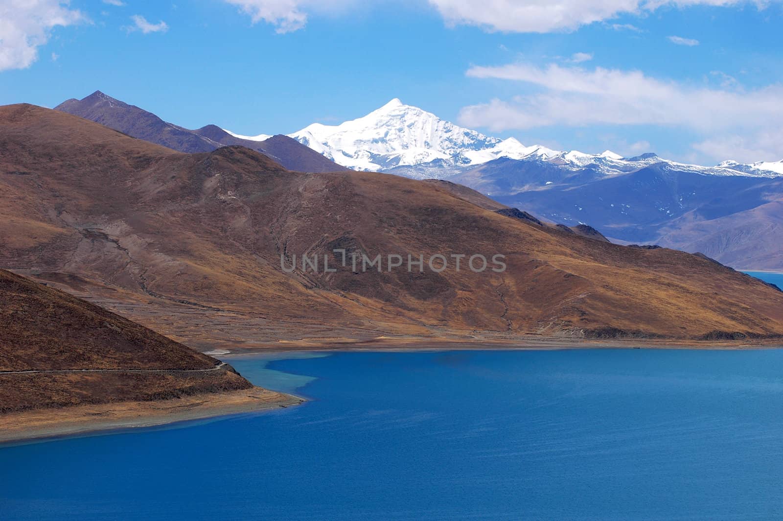 Landscape of snow mountains and blue lake in Tibet