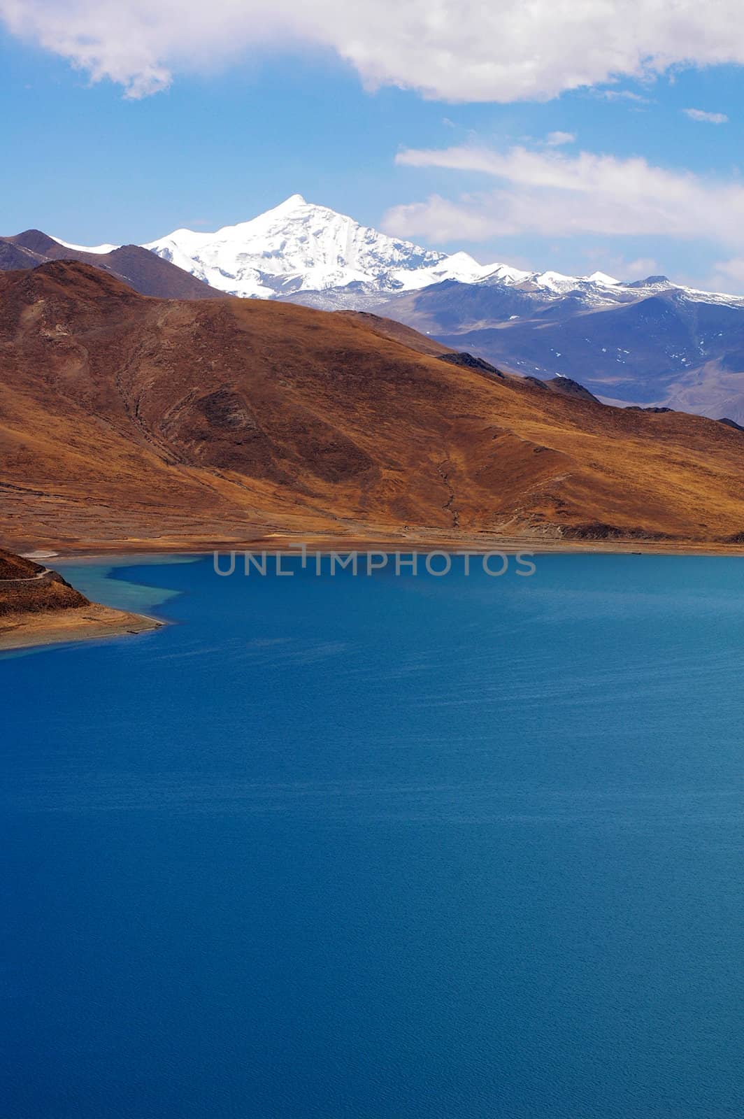 Landscape of snow mountains and blue lake in Tibet