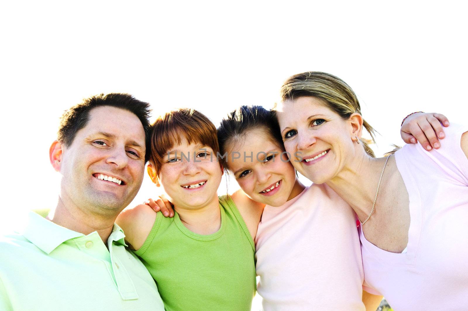 Portrait of happy family of four hugging and smiling