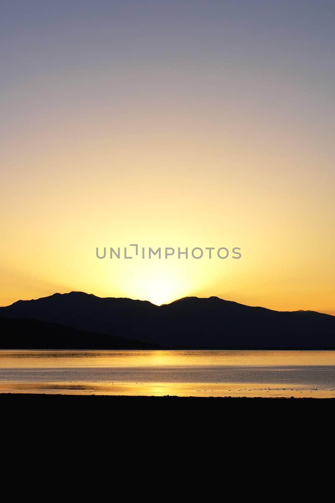 Landscape of mountains and lake at sunrise