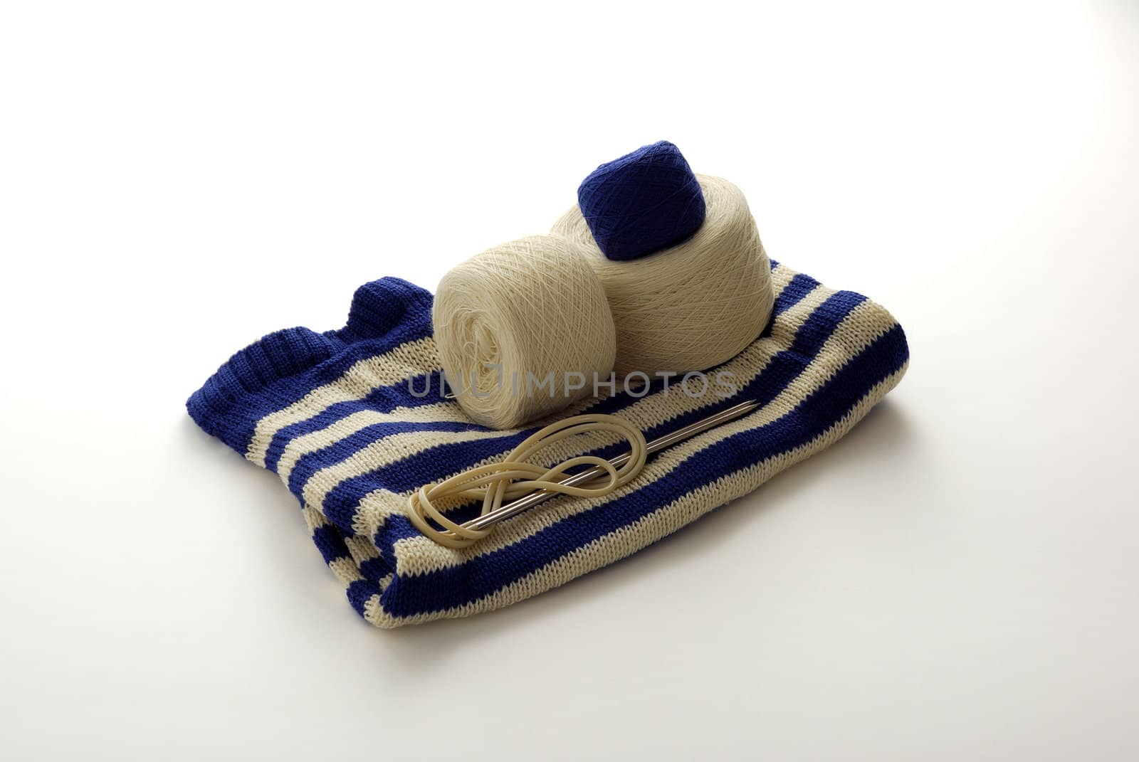 Blue white stripped knitting with clews and knitting needles