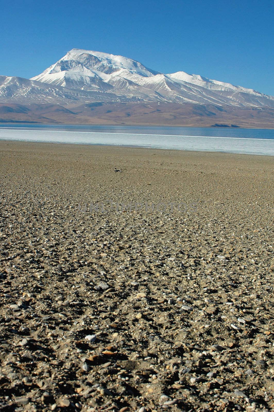 Landscape of snow mountains and blue lake in Tibet