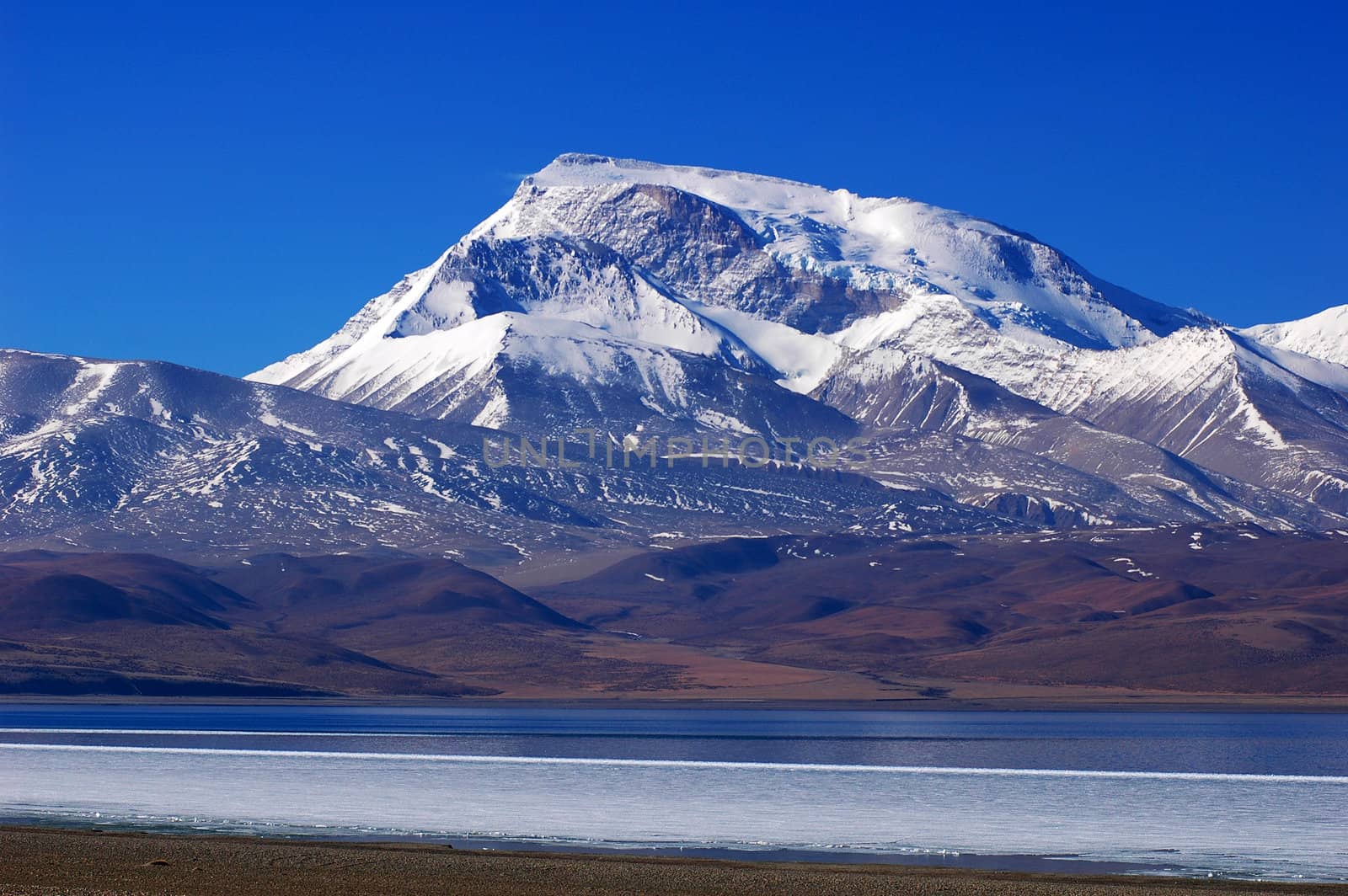 Landscape of snow mountains and blue lake in Tibet