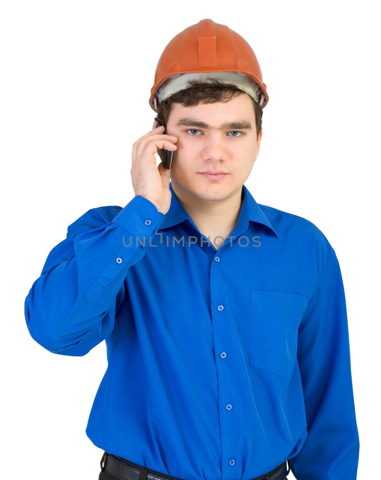 Builder in a helmet speaks on the phone