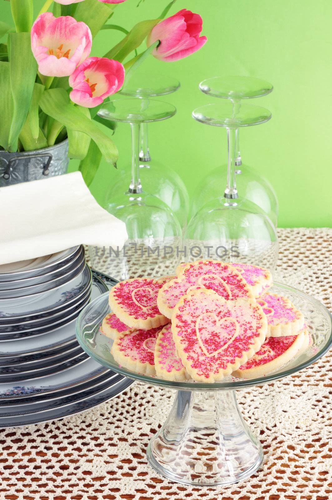 Valentine's Day cookies with dishes and flowers.