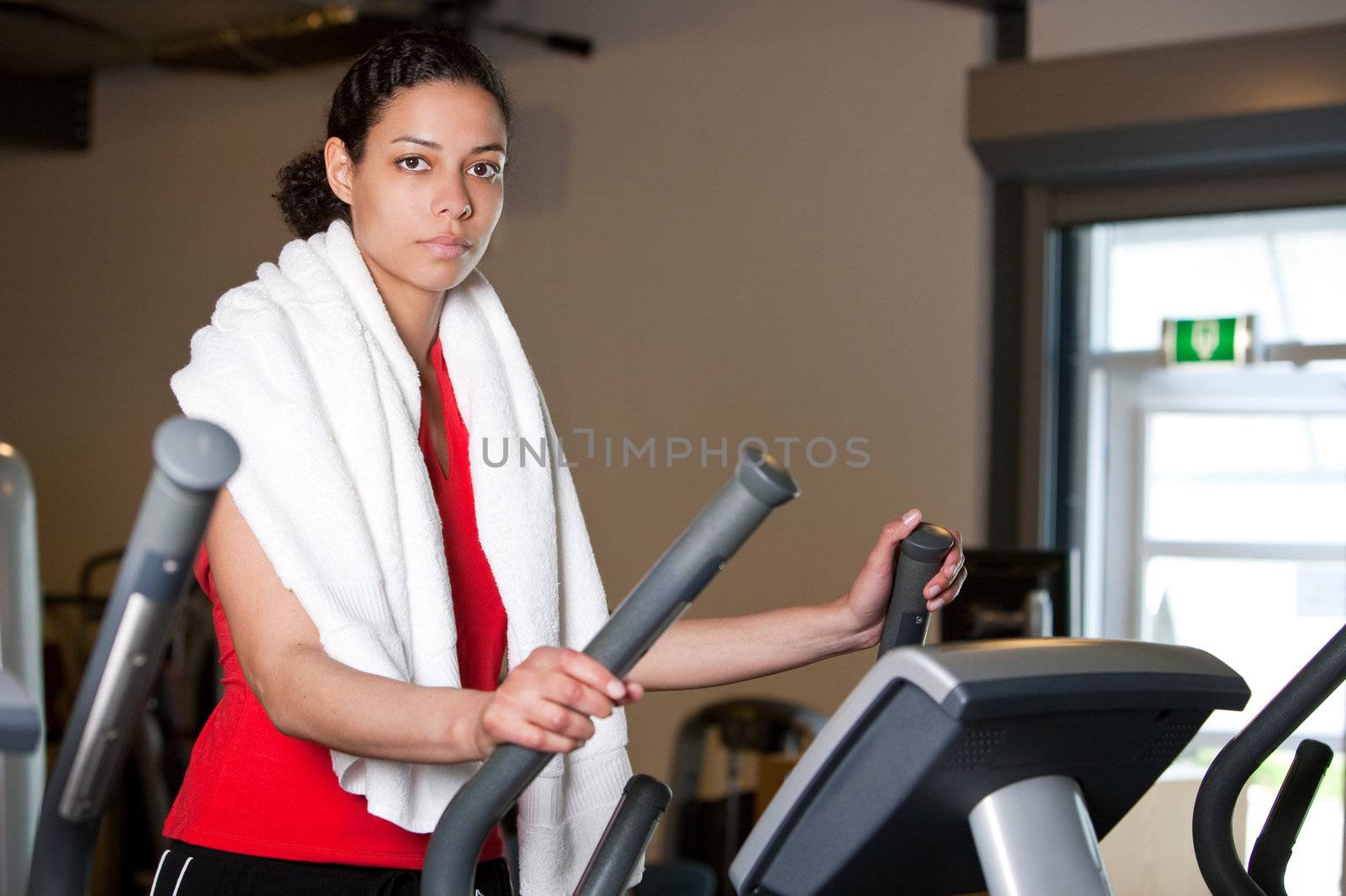Beautiful girl working out on the elliptical trainer