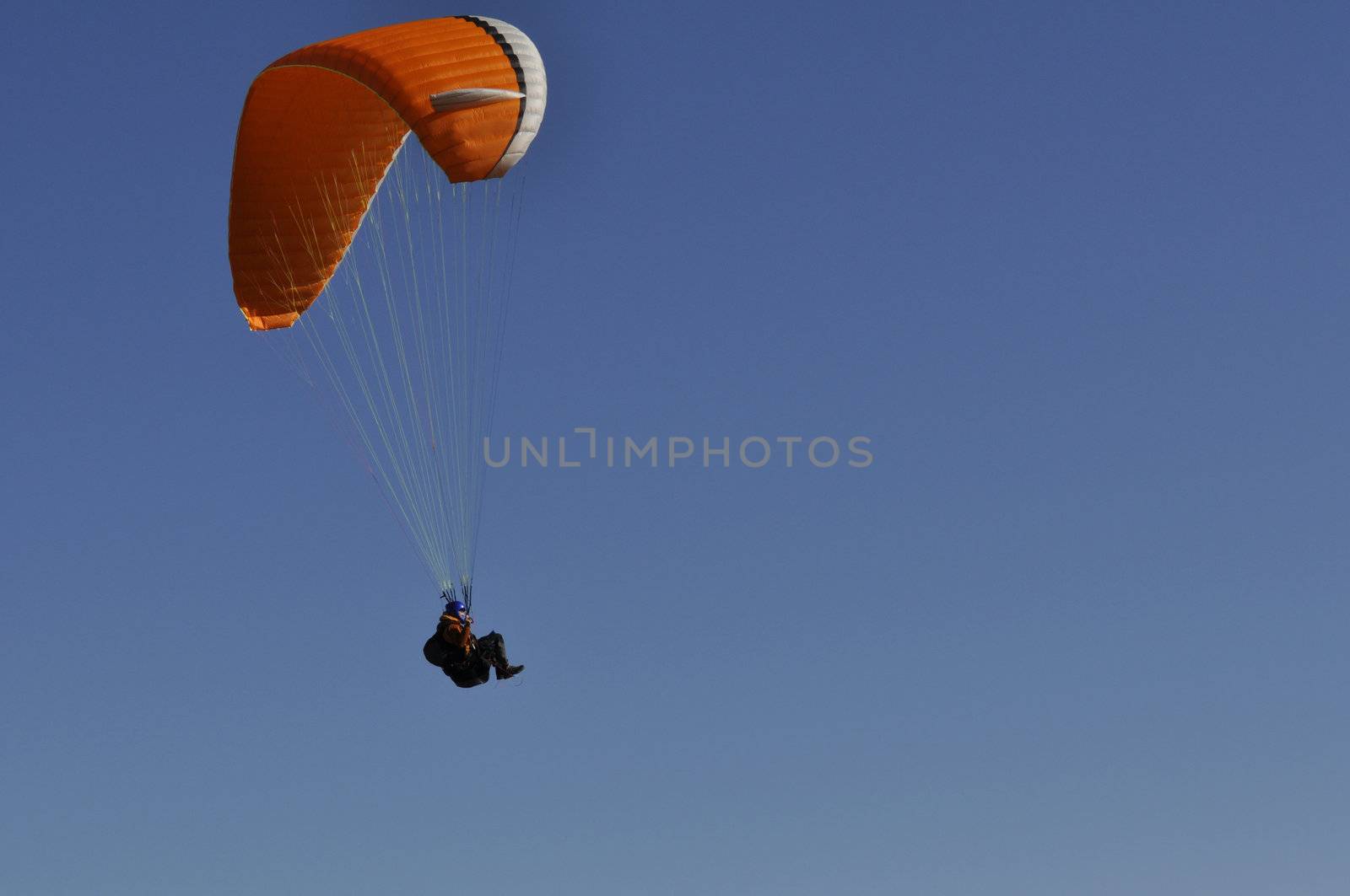 a paraglider in the air in sunset