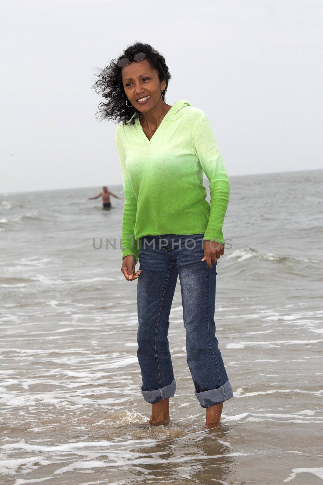Beautiful black woman standing in the sea