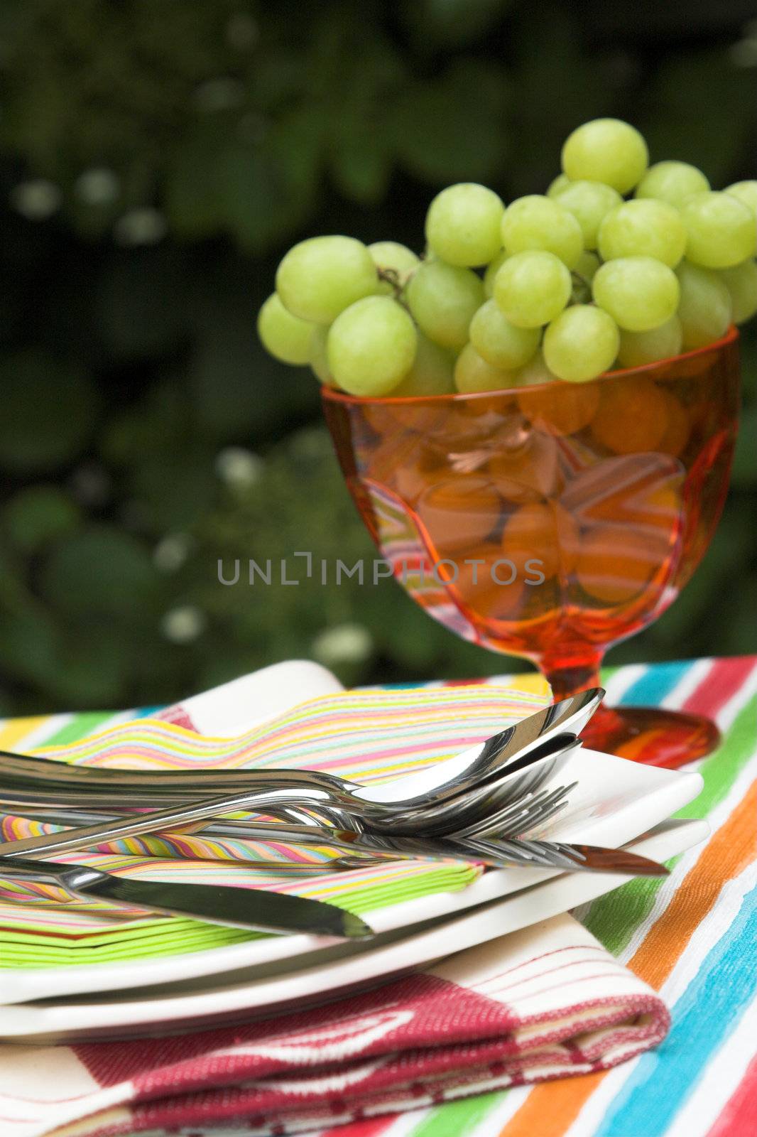 Outdoors setting for a table for two people (shallow dof, focus on cutlery)