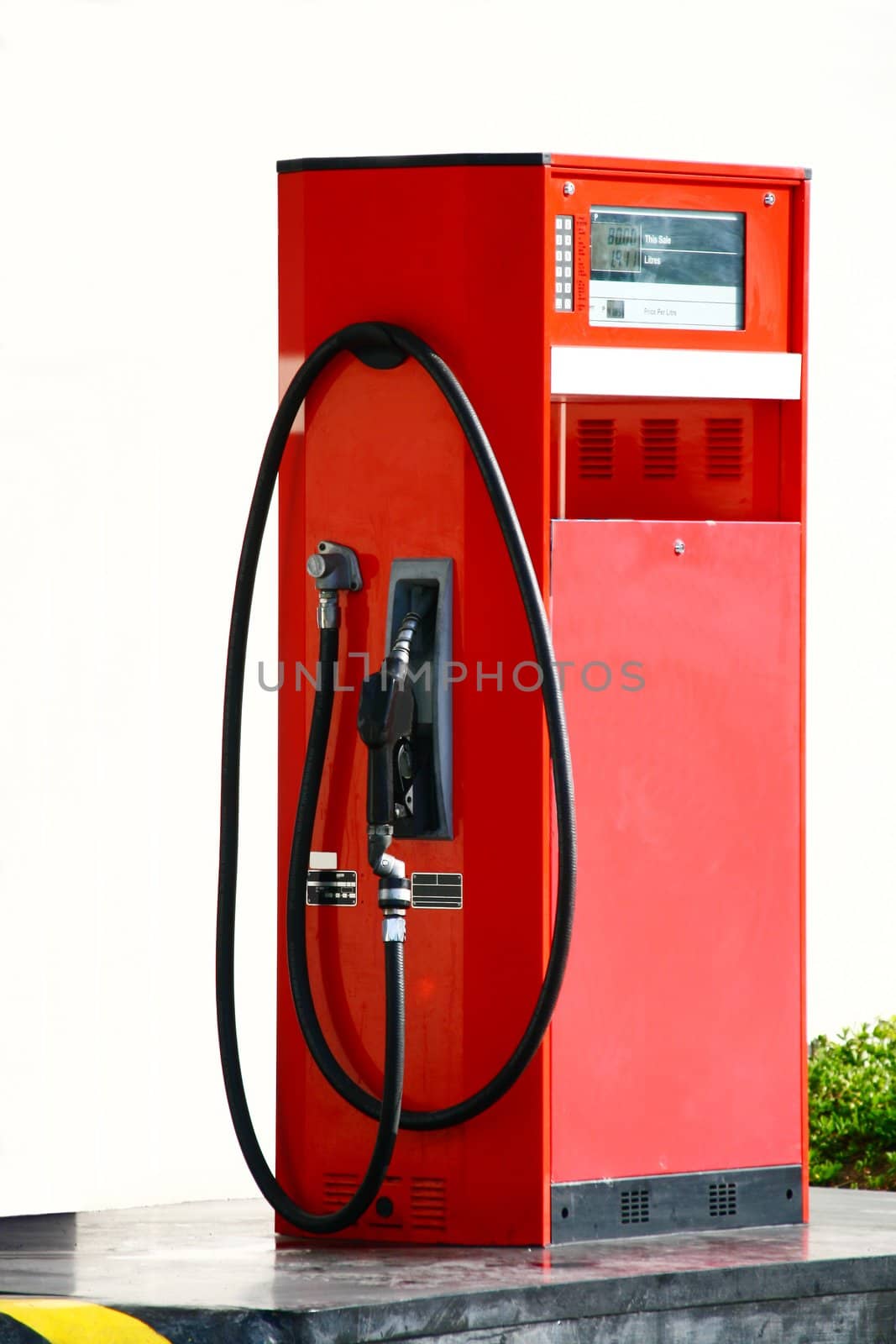 shabby lone gasoline pump on a self-service station
