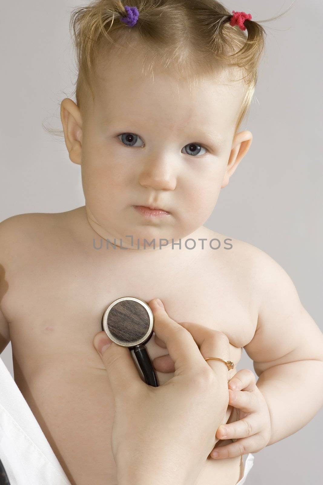 little girl examined by the pediatrician